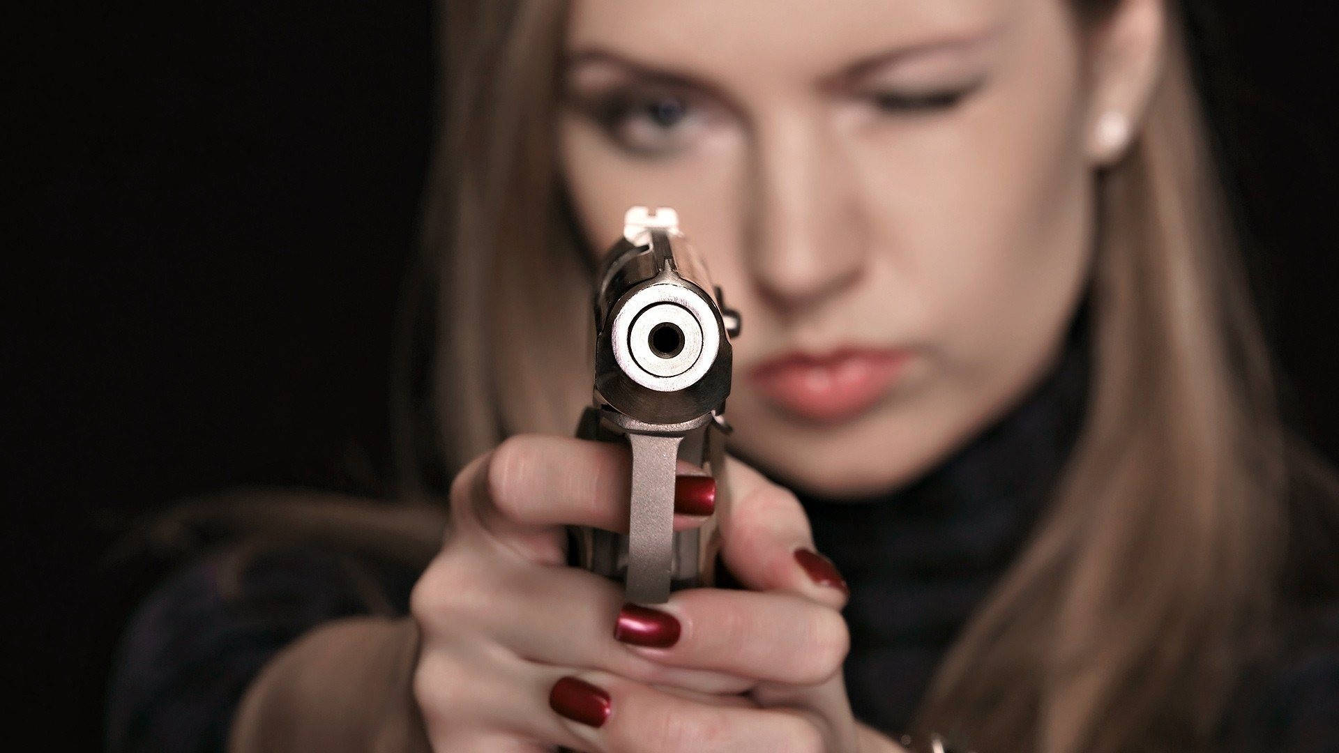Woman Pointing And Shooting A Gun Background