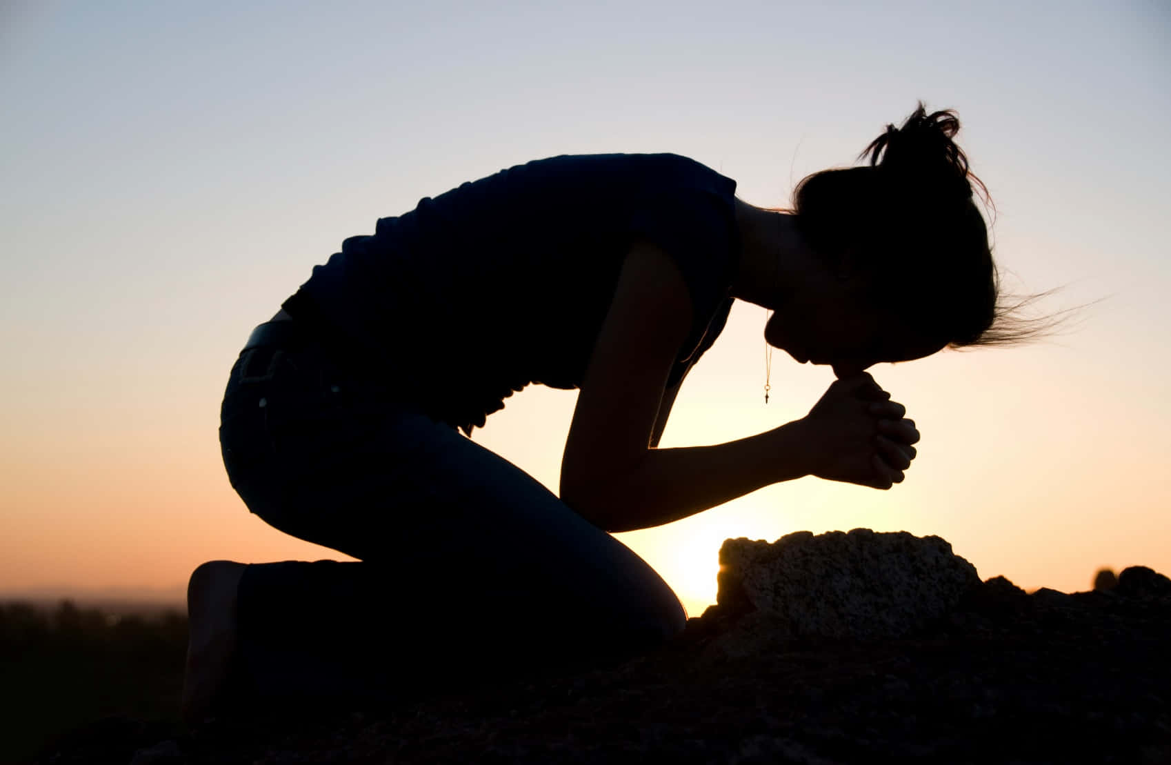 Woman Praying And Kneeling Silhouette