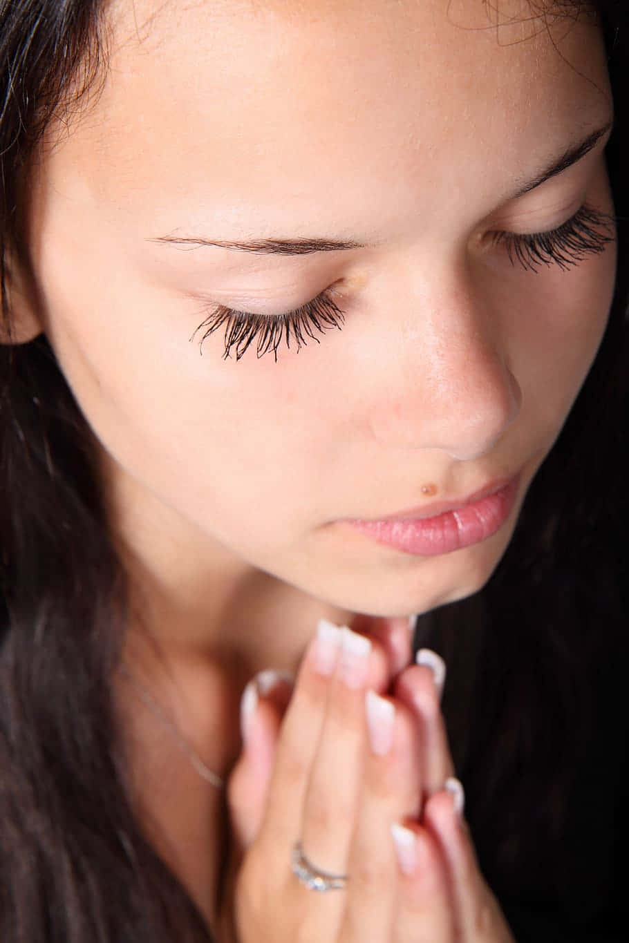 Woman Praying Closed Eyes Overhead Shot Background