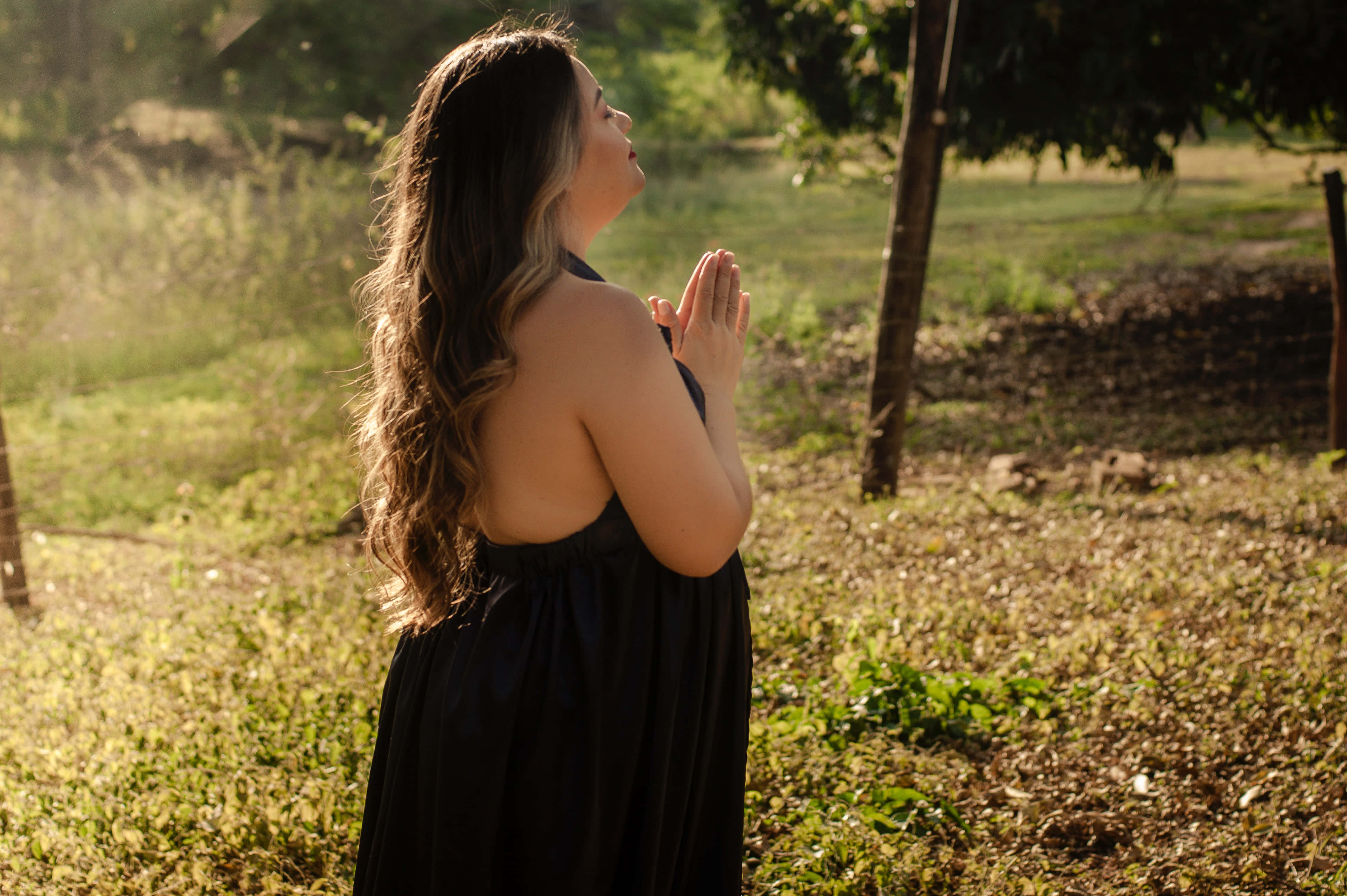 Woman Praying In A Black Dress