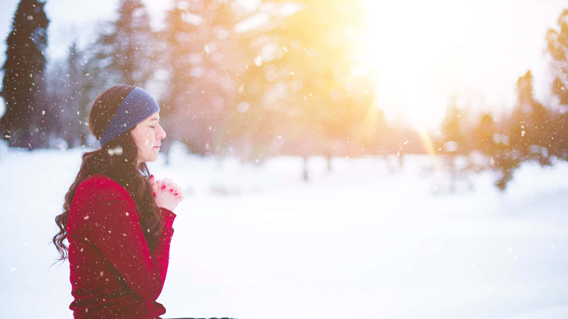 Woman Praying On The Snow Background