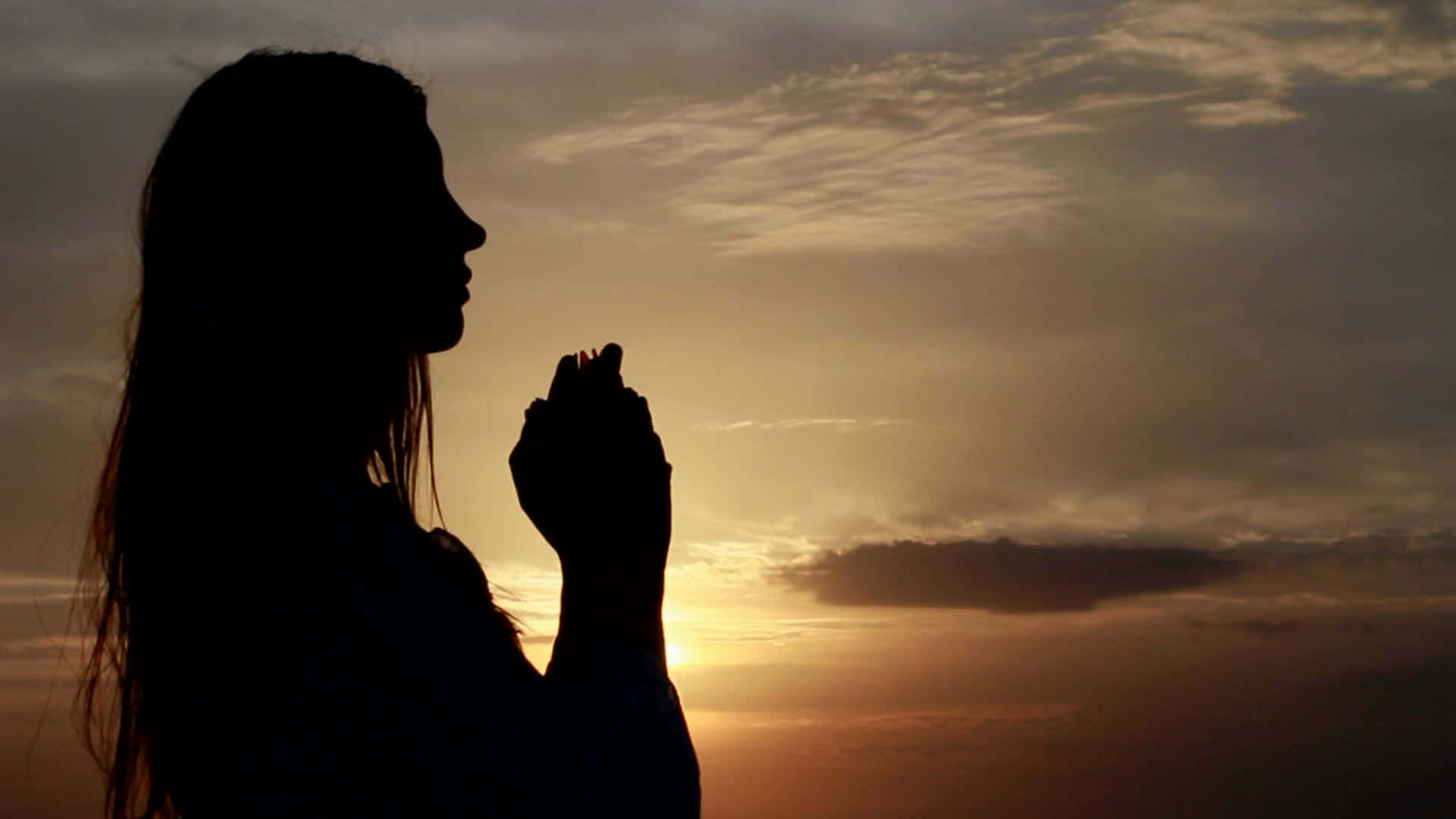 Woman Praying Silhouette At The Beach