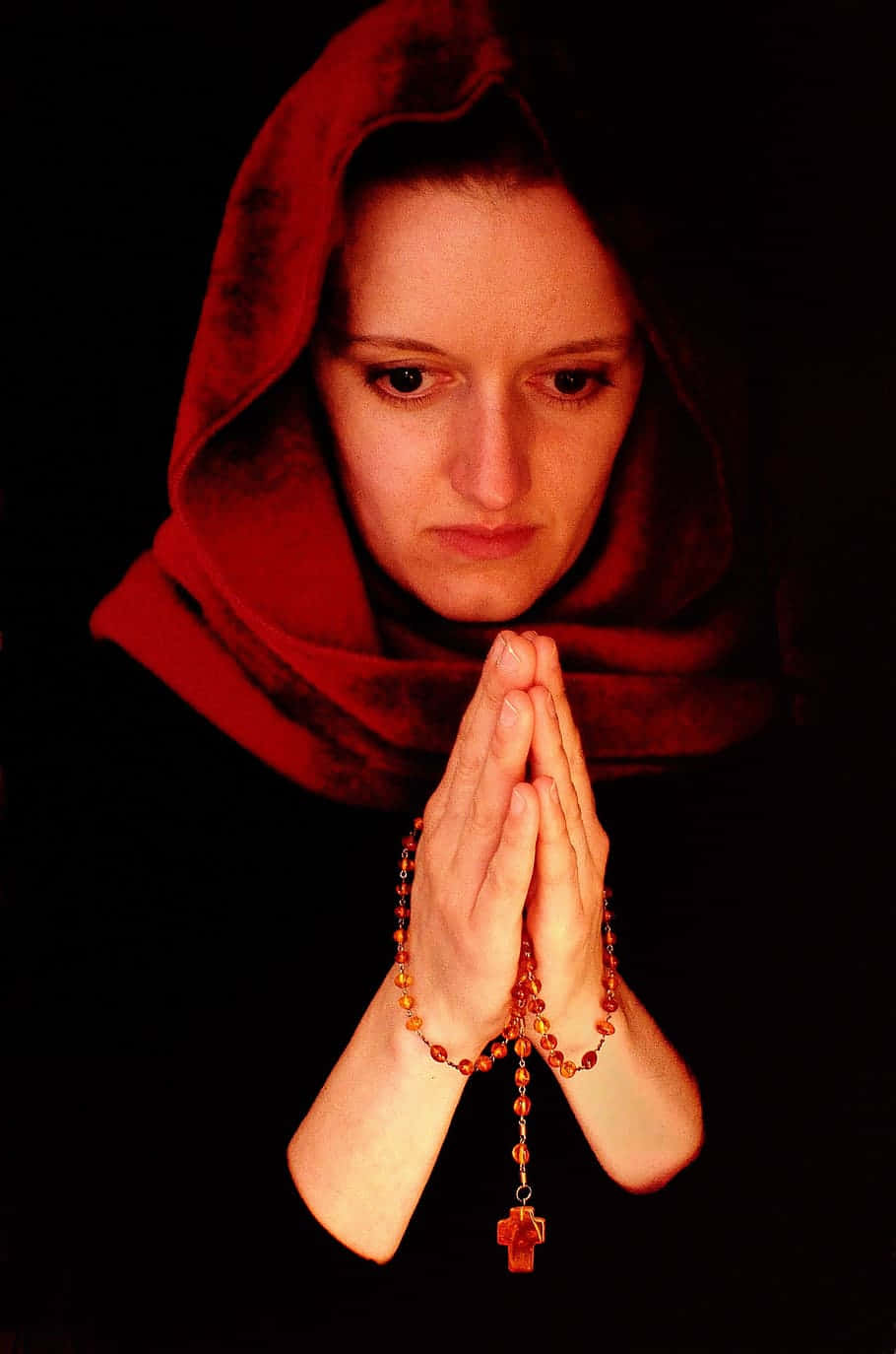 Woman Praying With A Red Scarf Background