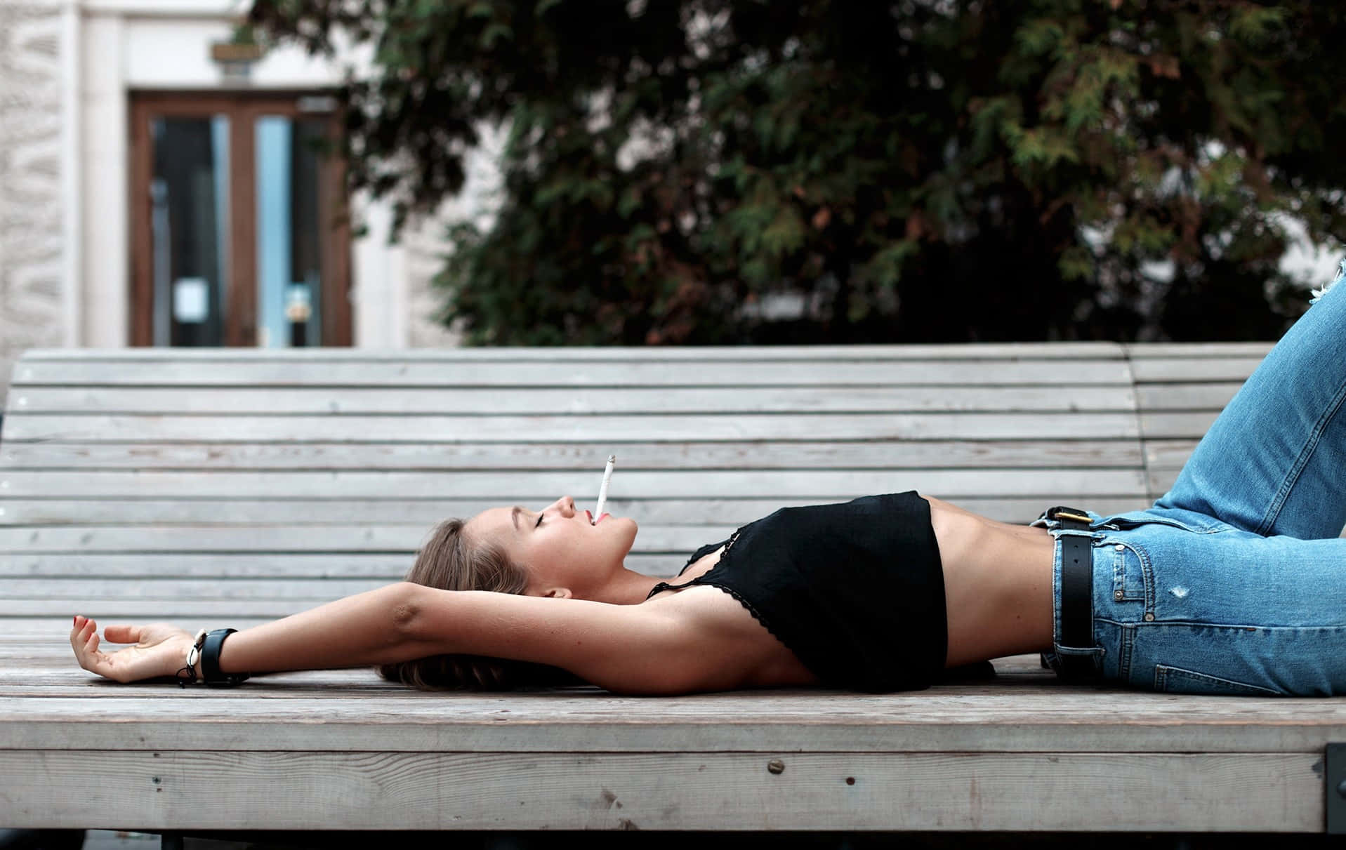 Woman Profile Lying On The Park Bench Background