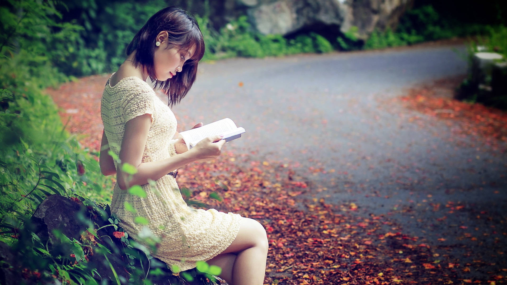 Woman Reading Beside Road