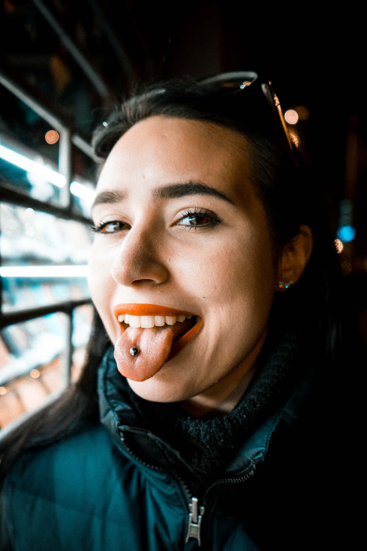 Woman Showcasing Tongue Piercing Background