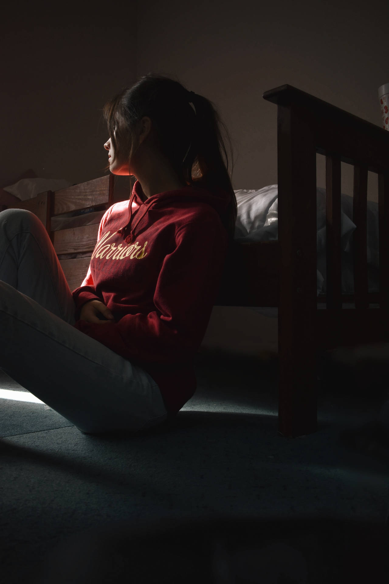 Woman Sitting Alone Near Bed Background