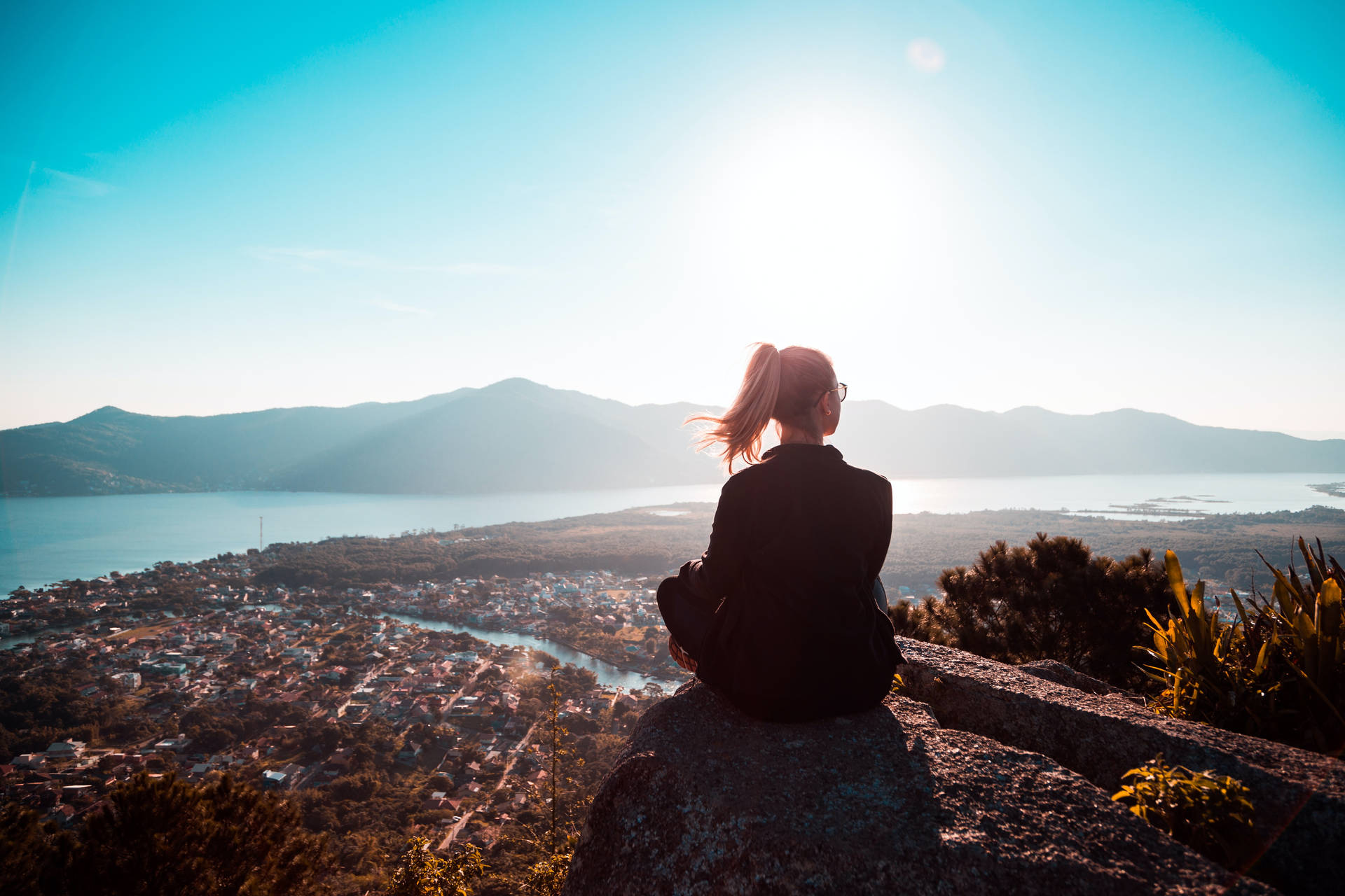 Woman Sitting Alone On Rock Background