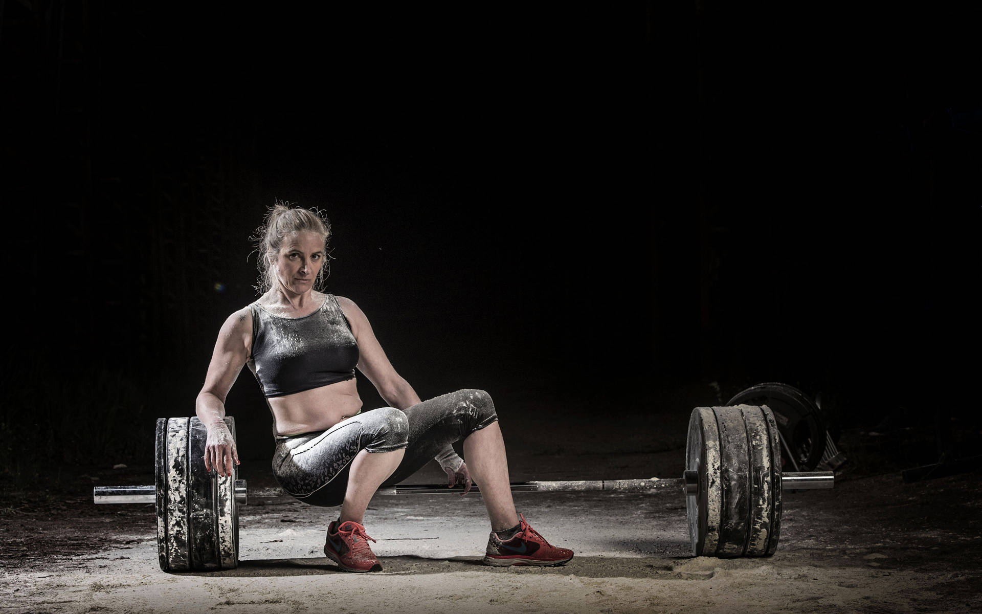 Woman Sitting On Barbell Background