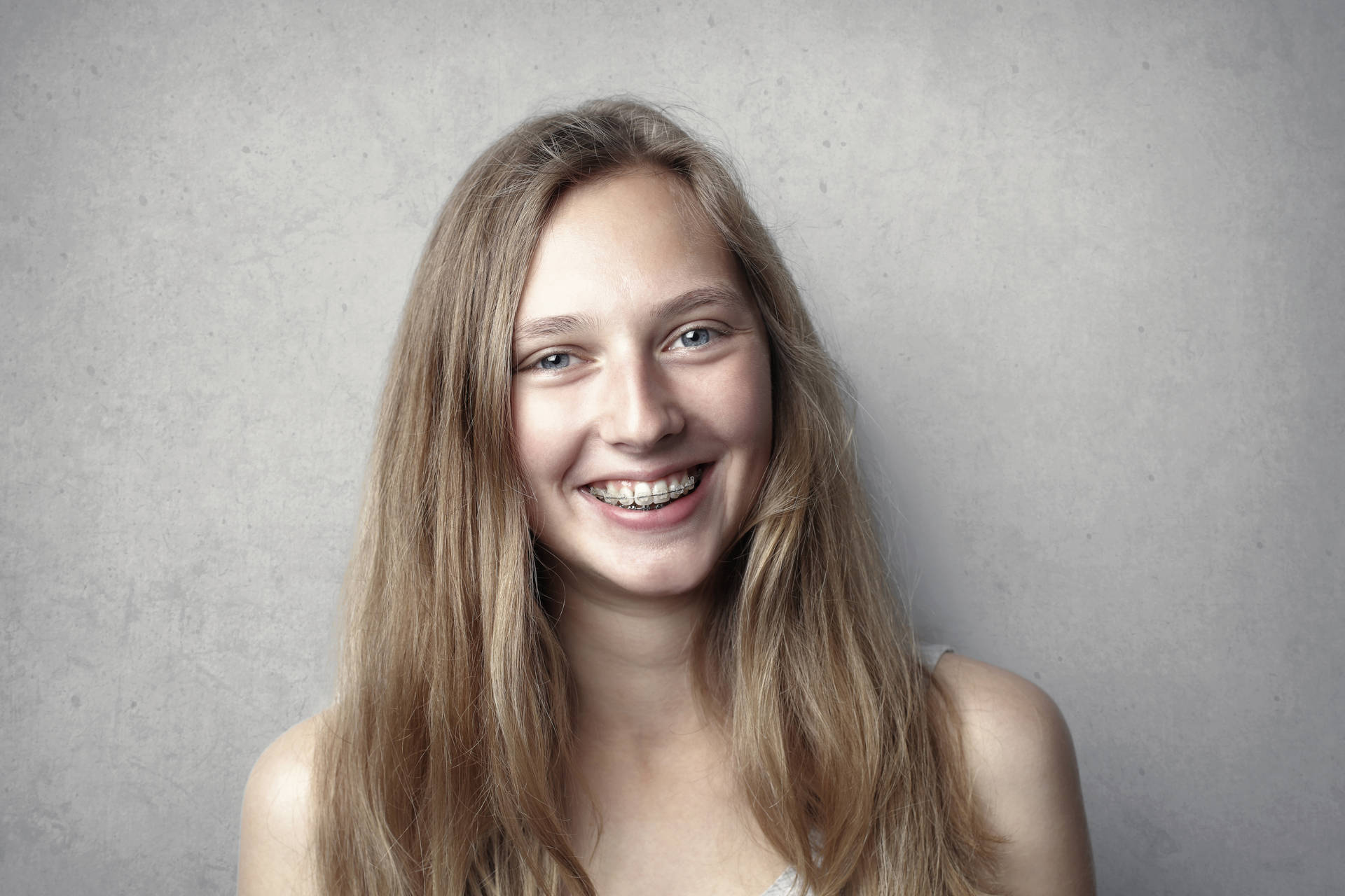 Woman Smiling With Braces Headshot Background