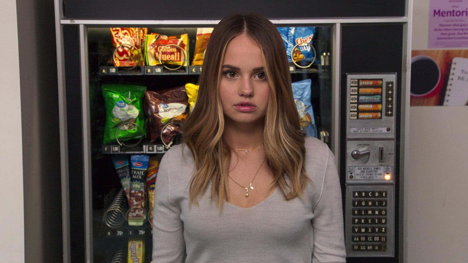 Woman Standing In Front Of Vending Machine Background