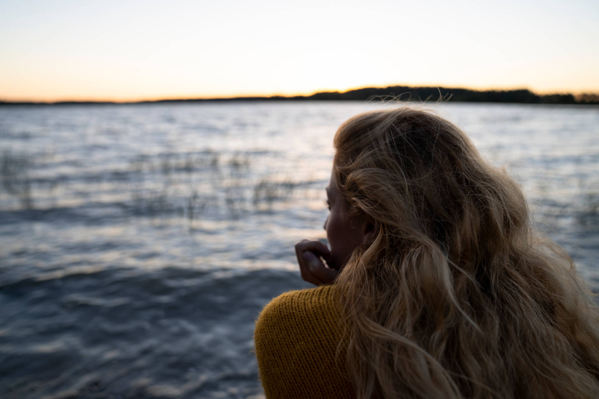 Woman Staring At Lake Finland Background