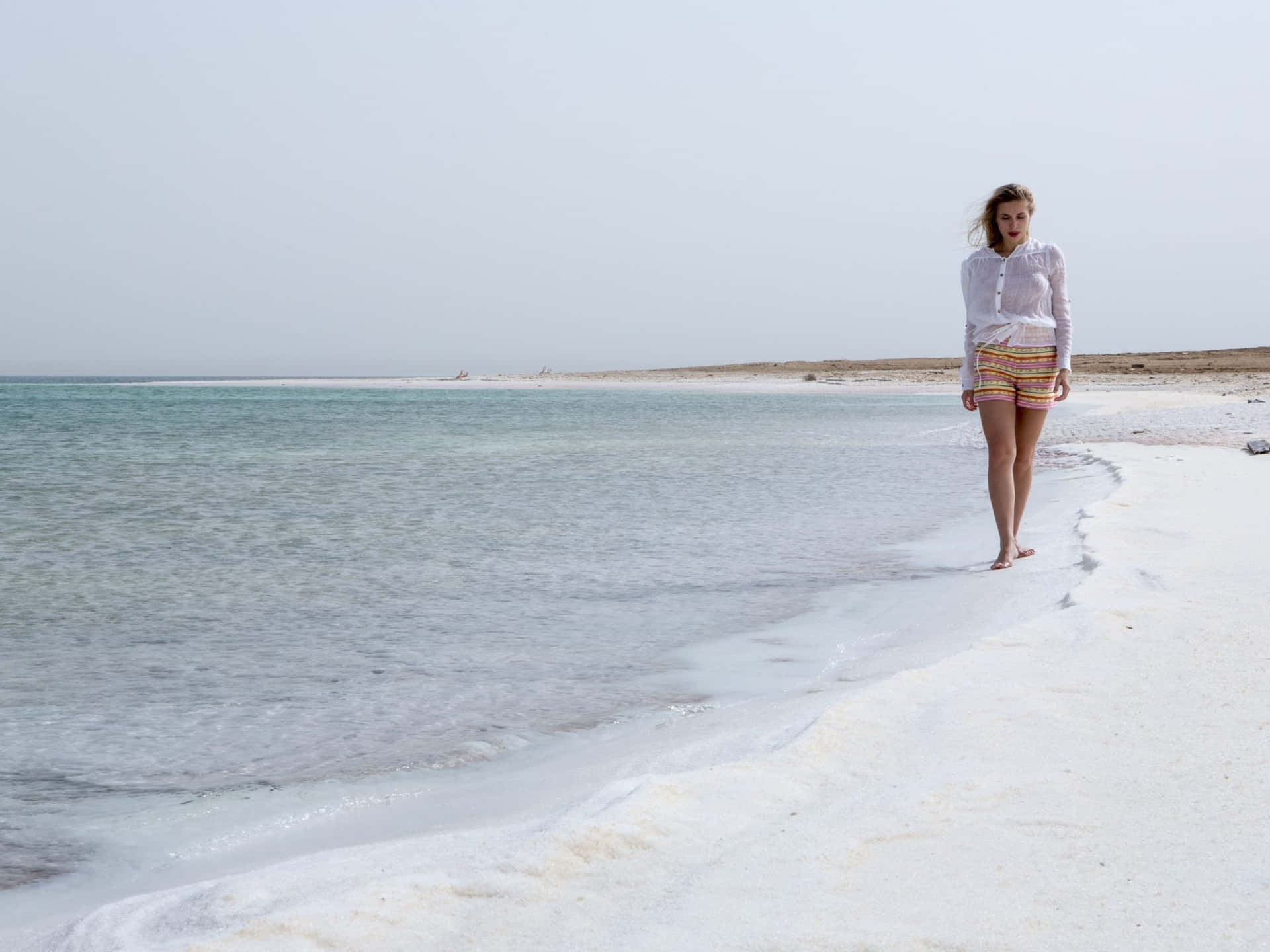 Woman Walking On Dead Sea Shore Background