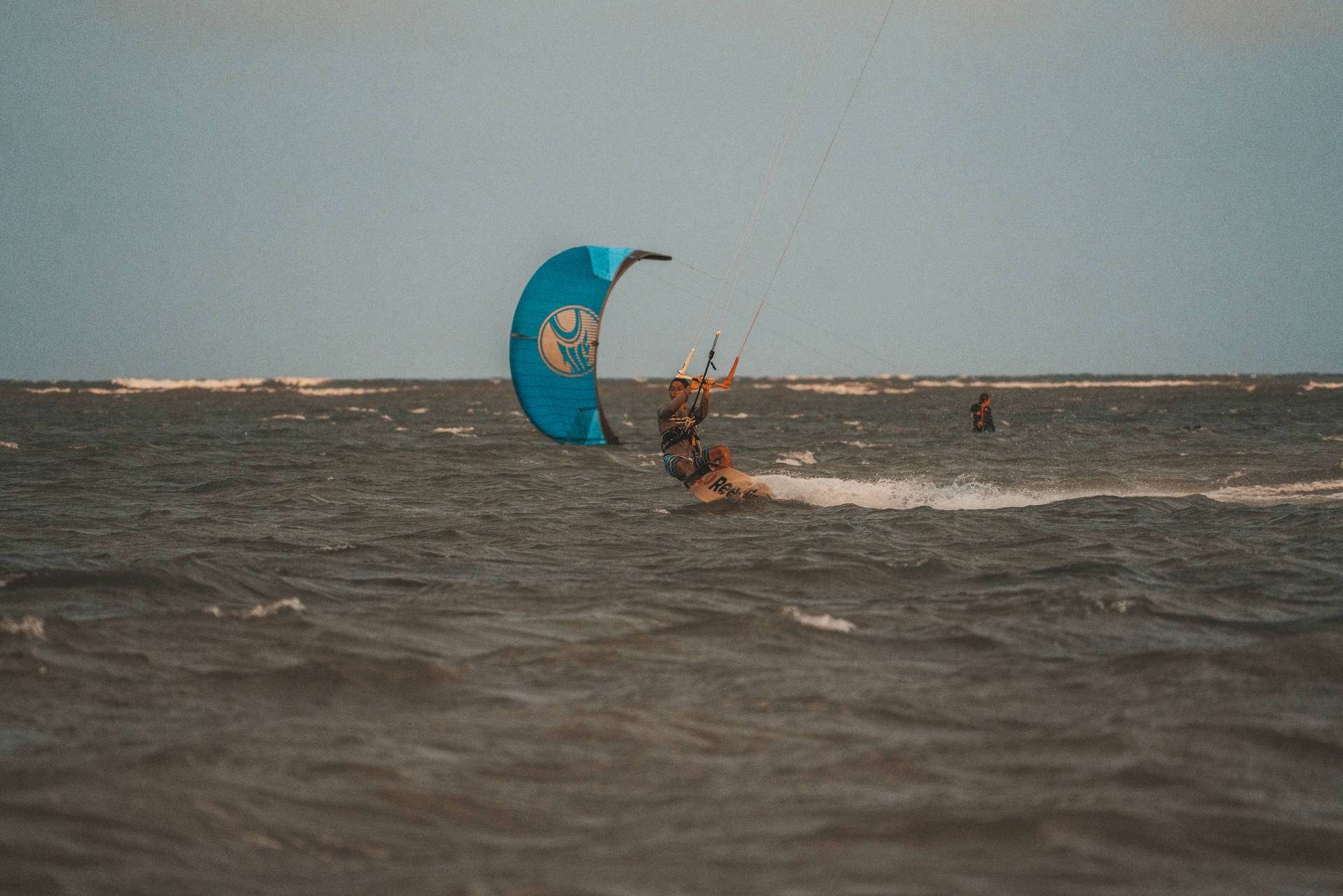 Woman Windsurfer In Ocean Background