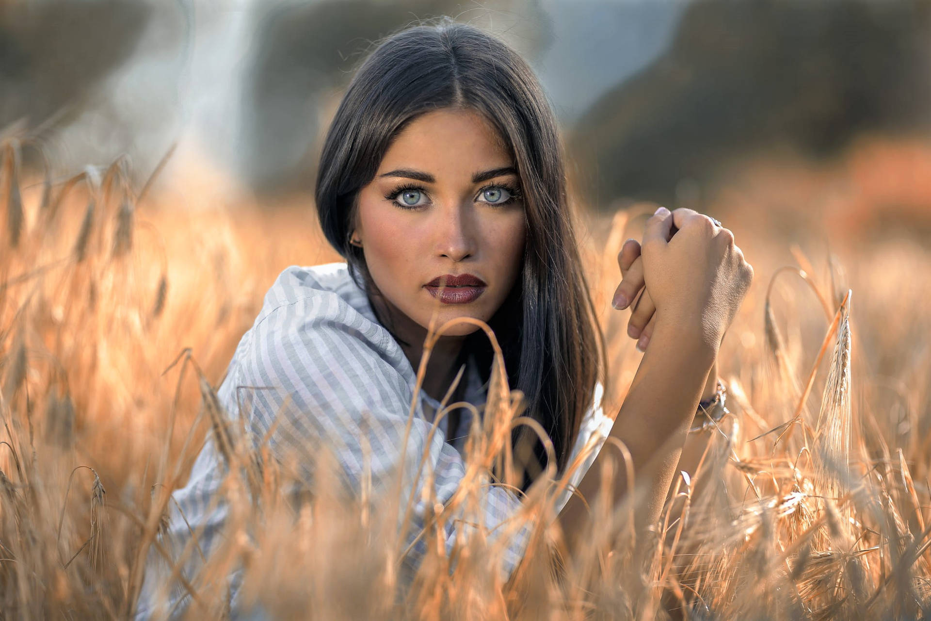 Woman With Blue Eyes In Wheat Field Background