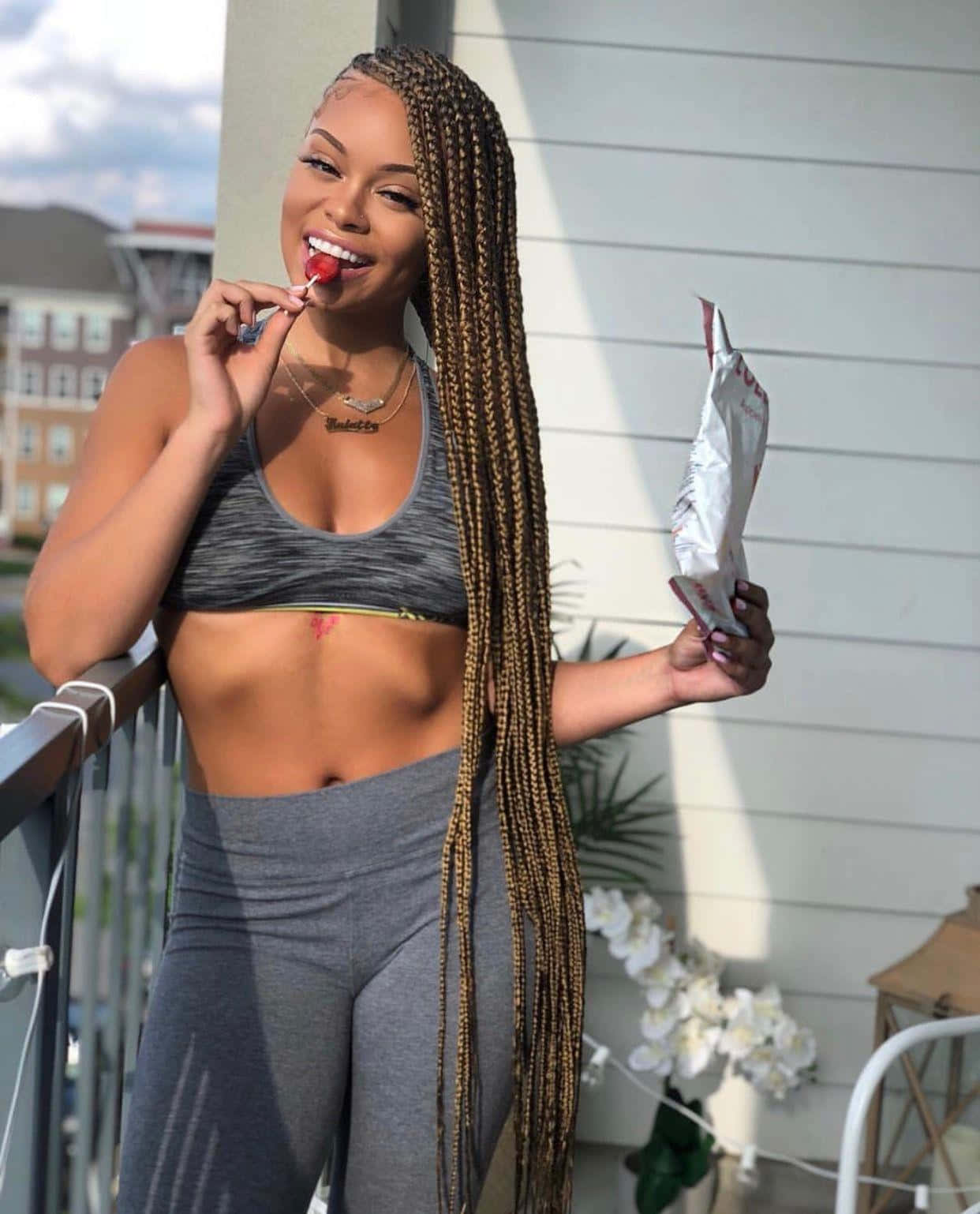 Woman With Braids Eating Candy Background