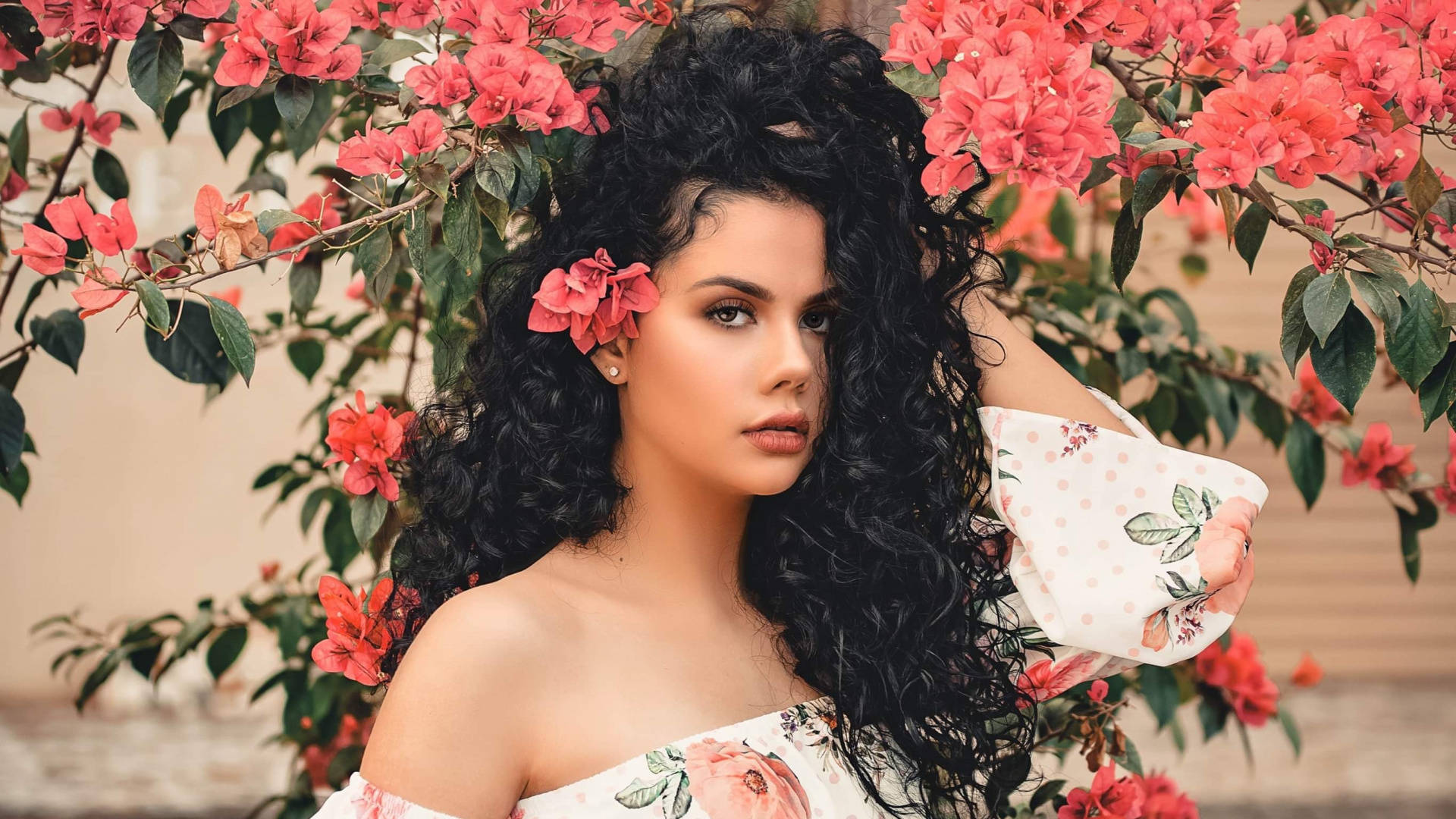 Woman With Curly Hair And Flowers Background