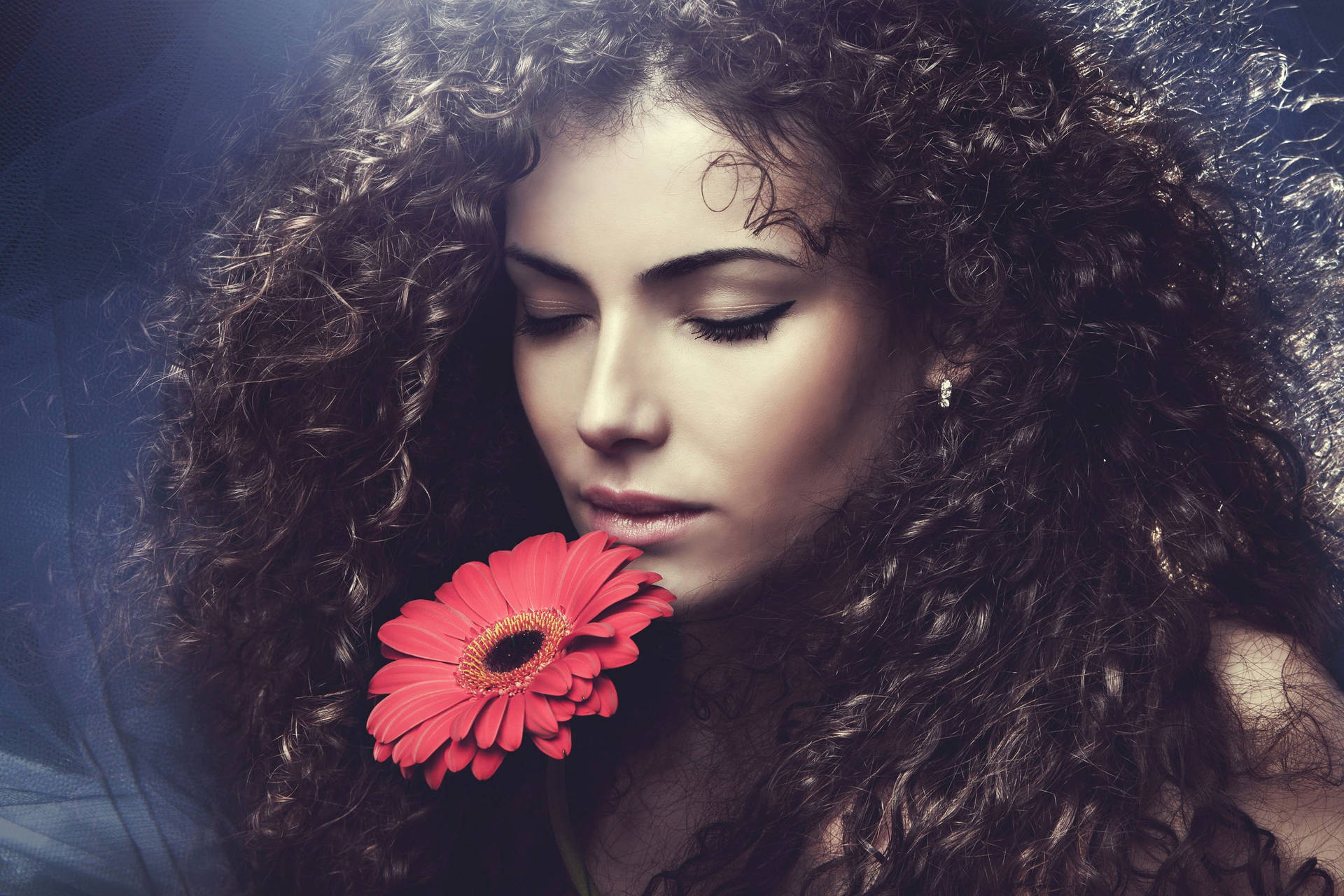 Woman With Curly Hair Holding Flower