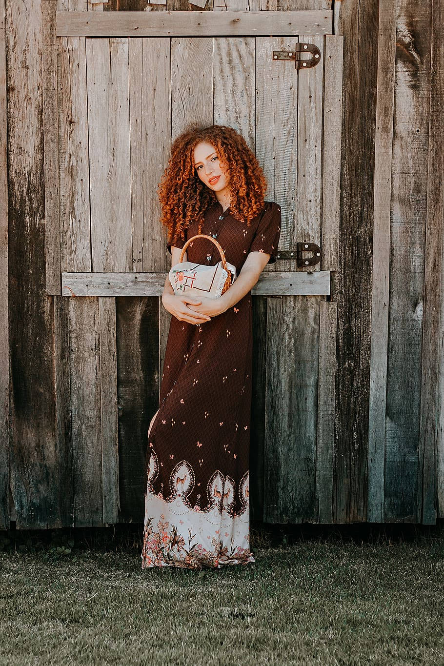 Woman With Curly Hair On Barn Background