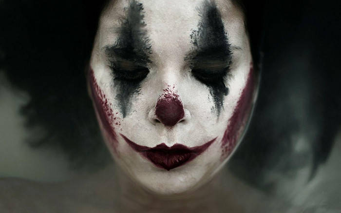 Woman With Sad Joker Makeup Background