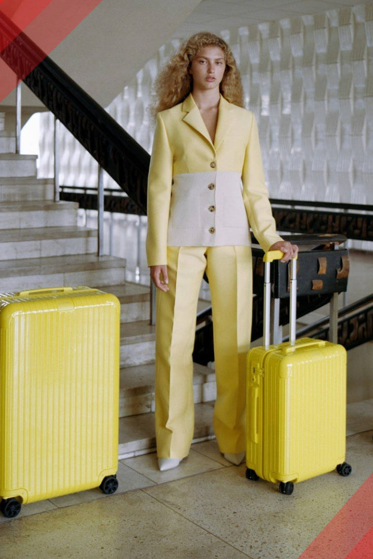 Woman With Two Rimowa Suitcases Background