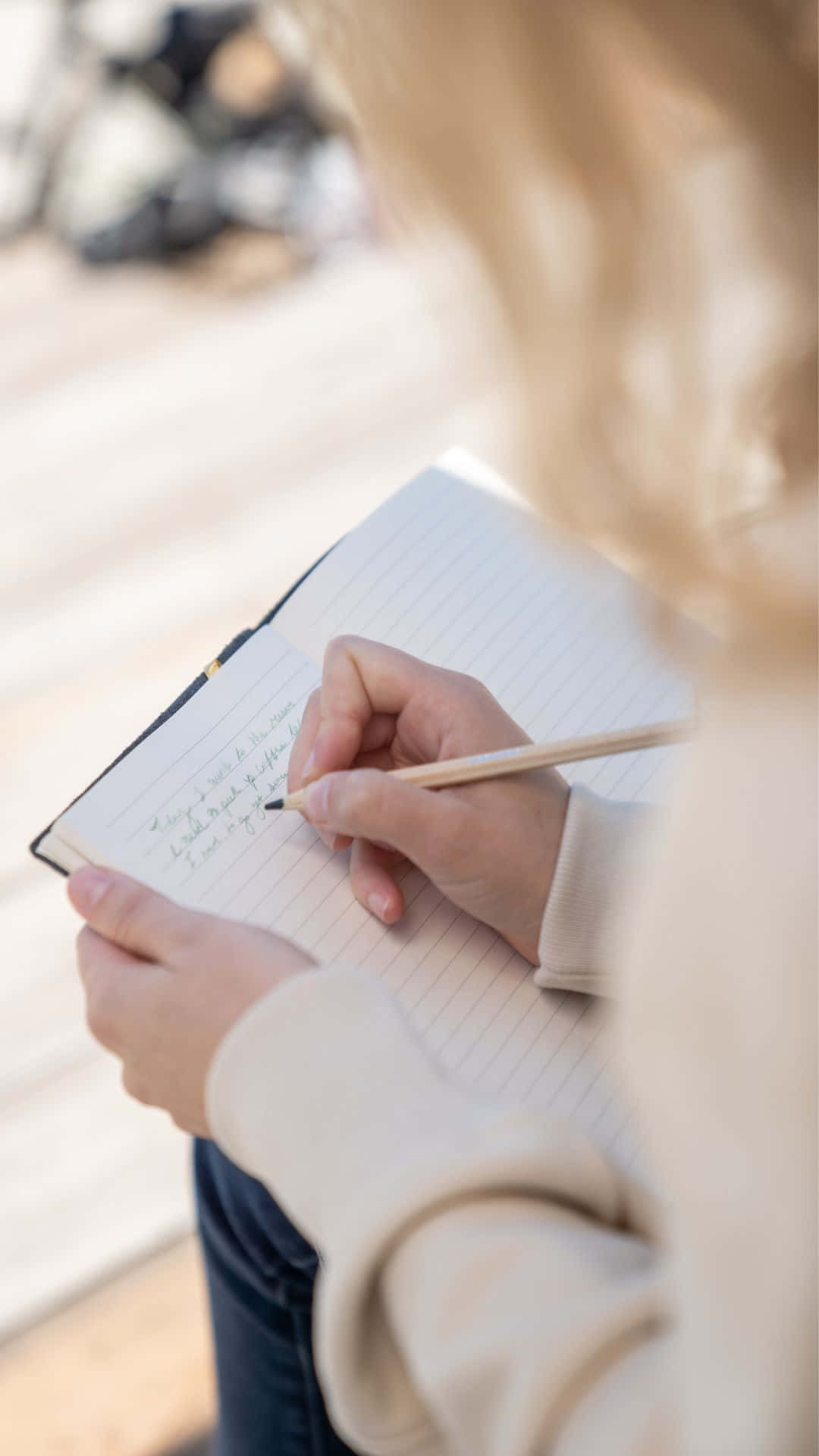 Woman Writingin Notebook Outdoors Background