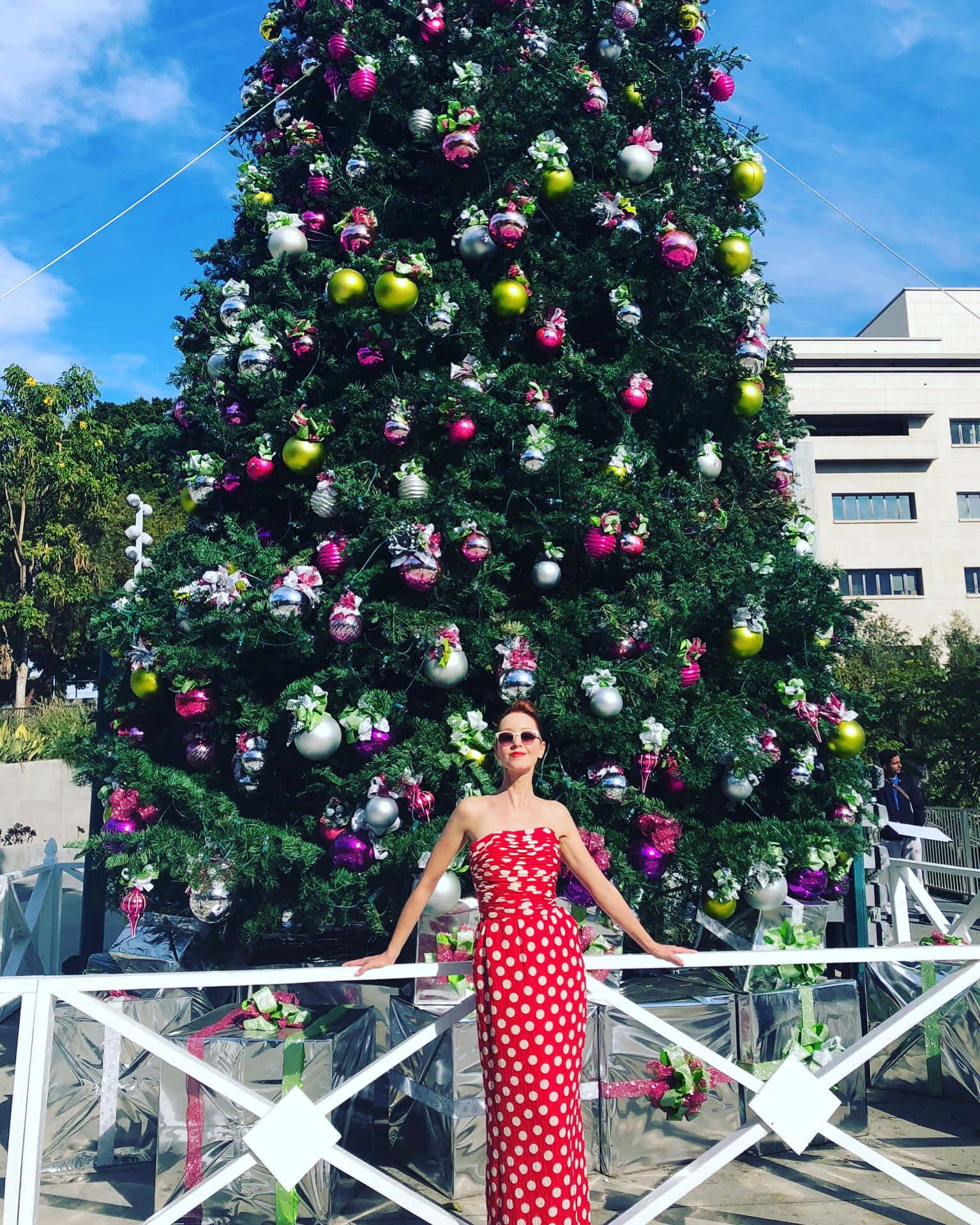 Womanin Red Dress Before Christmas Tree