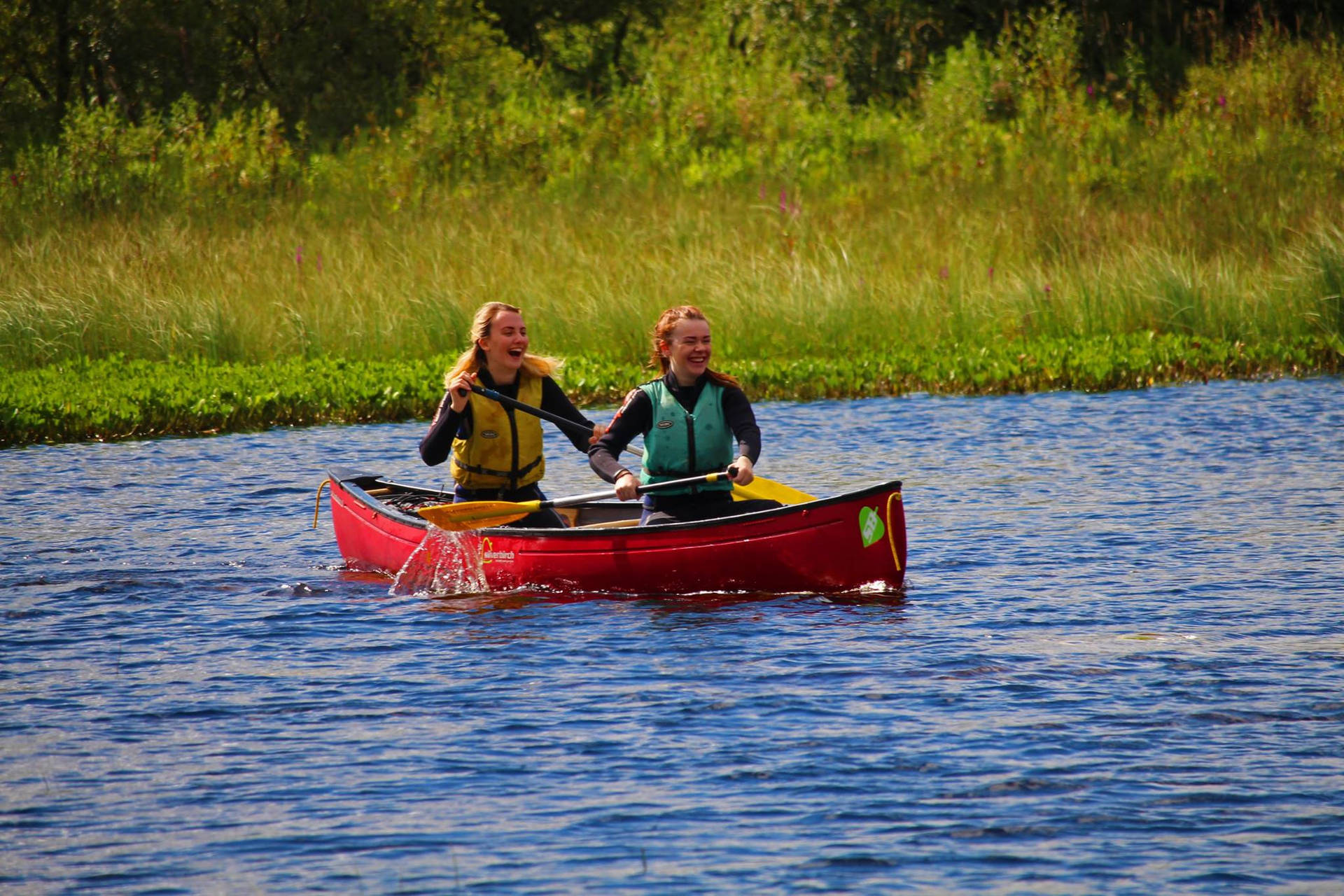 Women Canoeing Together