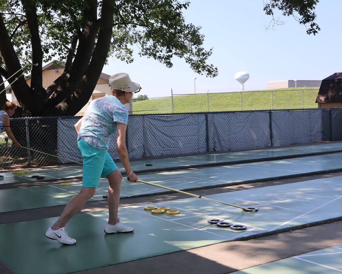 Women Playing In A Bluffton Shuffleboard Competition Background