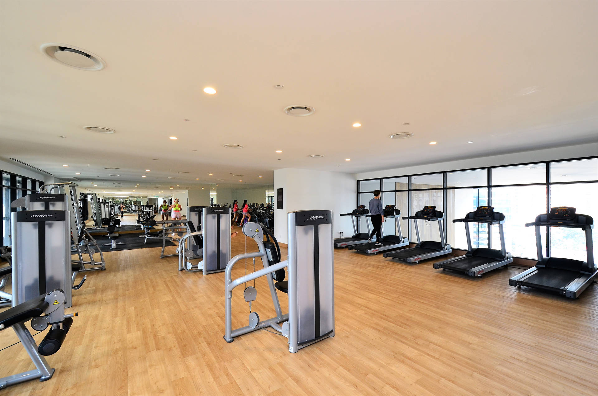 Wood-paneled Gym With Treadmills Background
