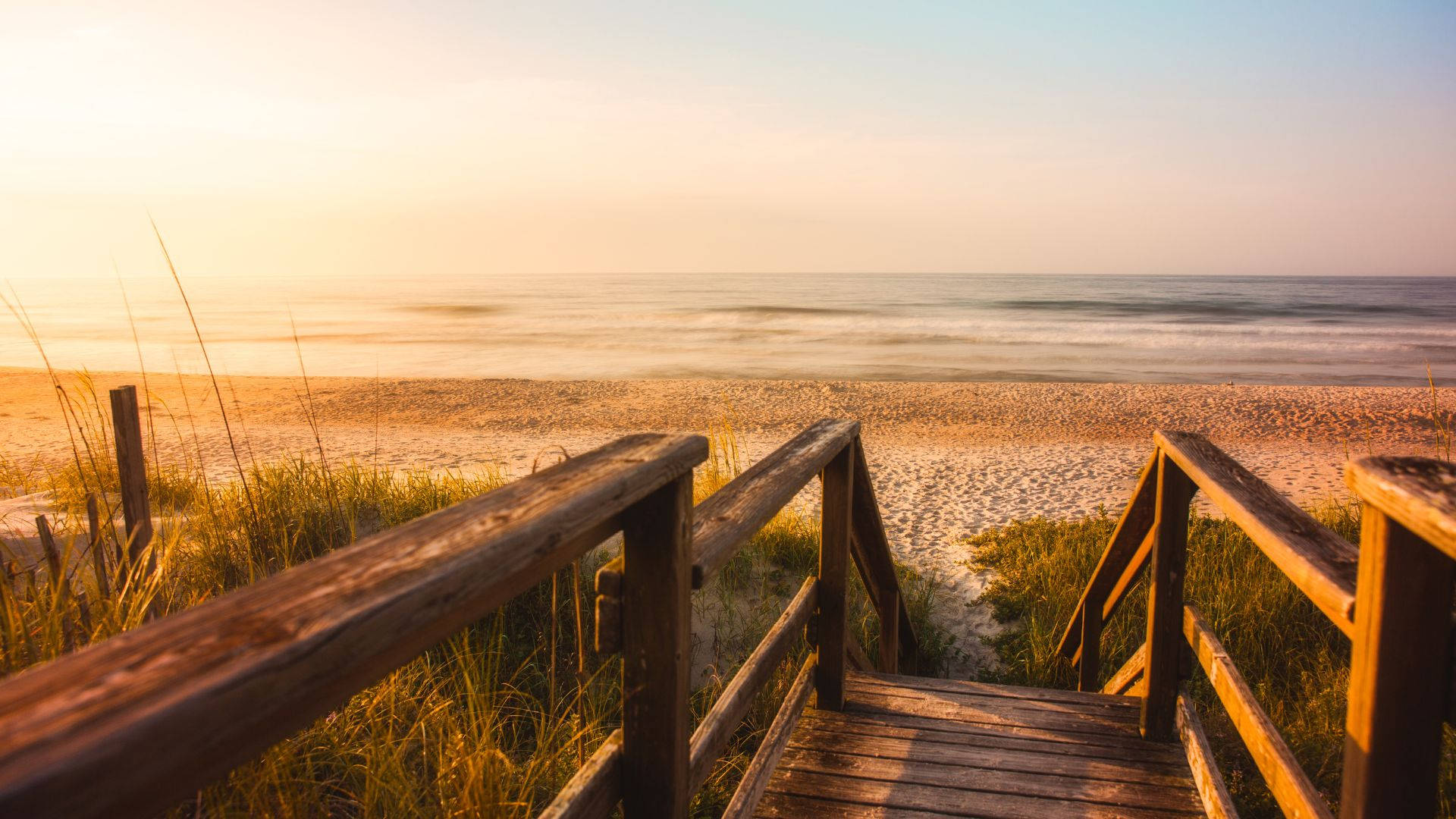 Wooden Boardwalk On A Beach Sunrise Background