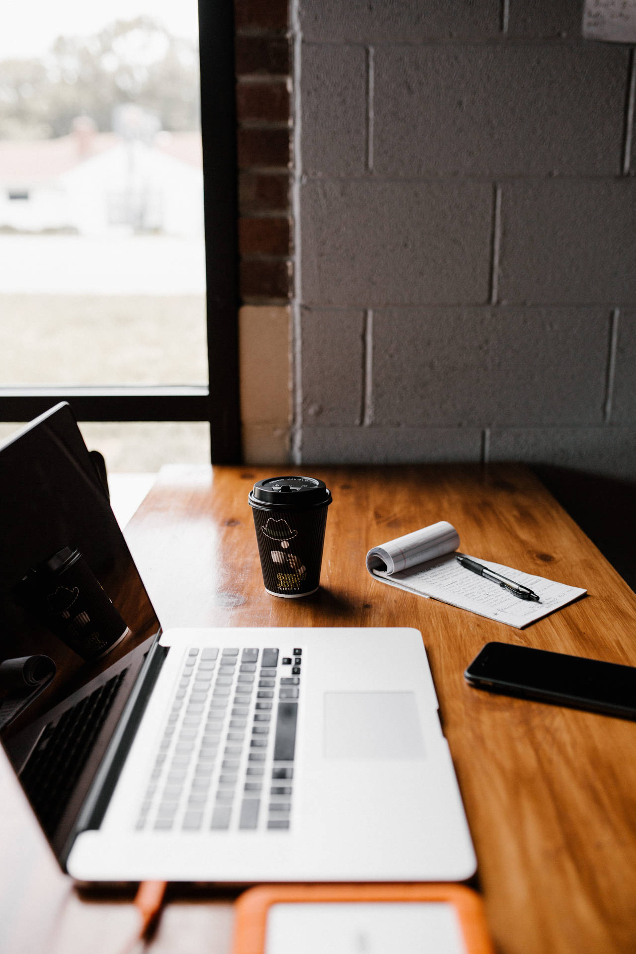 Wooden Iphone Desk Setup With Coffee Cup