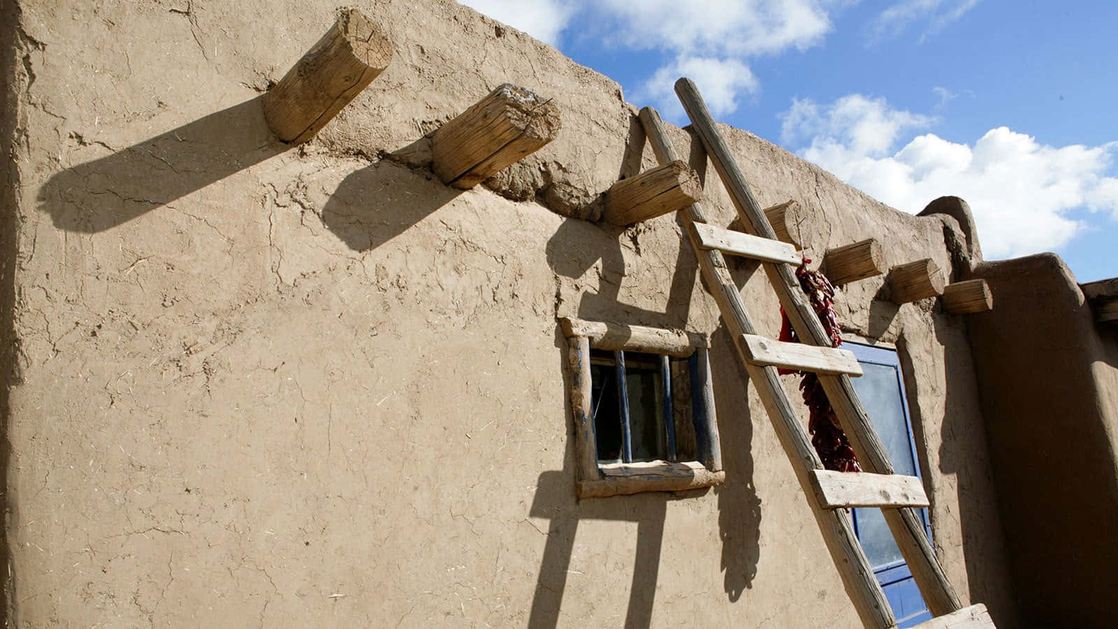 Wooden Ladders In Taos Pueblo Background