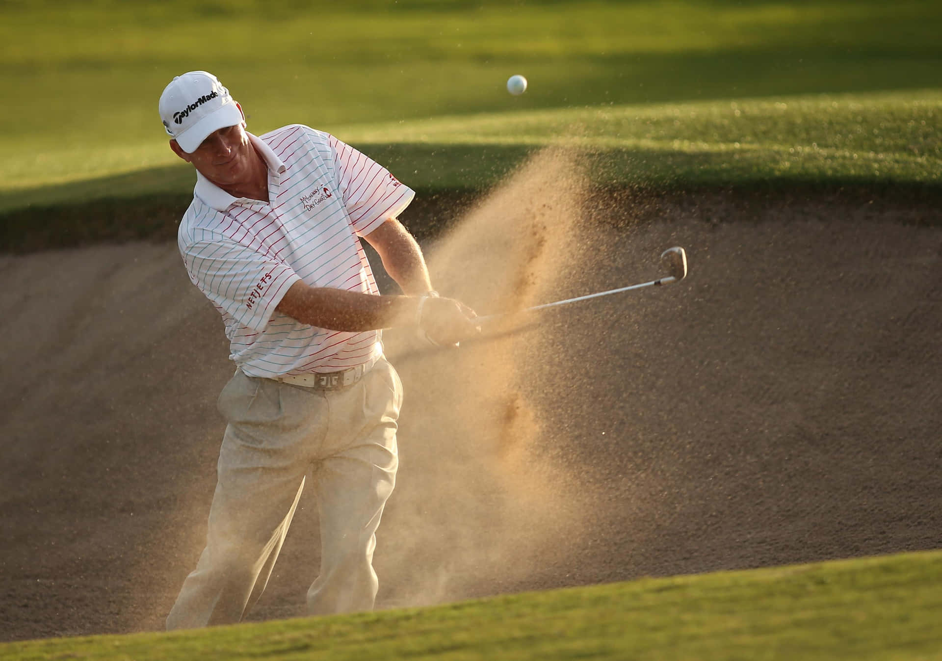 Woody Austin Hitting A Golf Ball Background