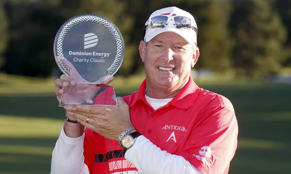 Woody Austin Holding A Trophy Background