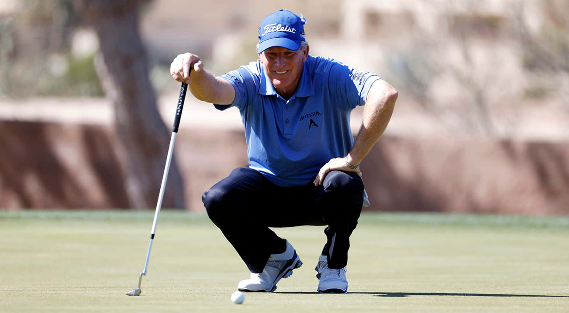 Woody Austin Squatting In A Field