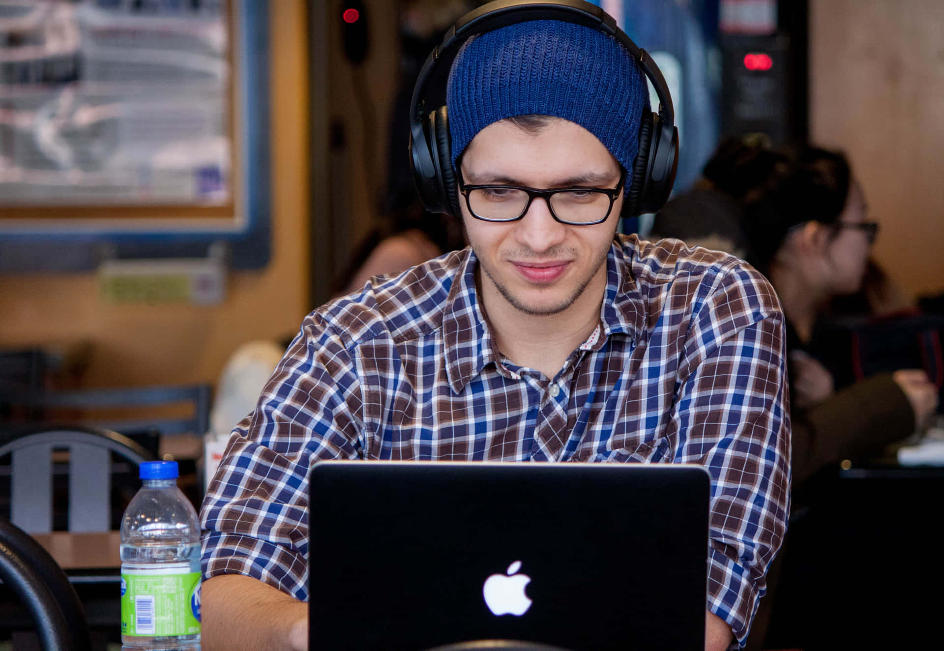 Working On The Laptop With Stylish Headphones. Background