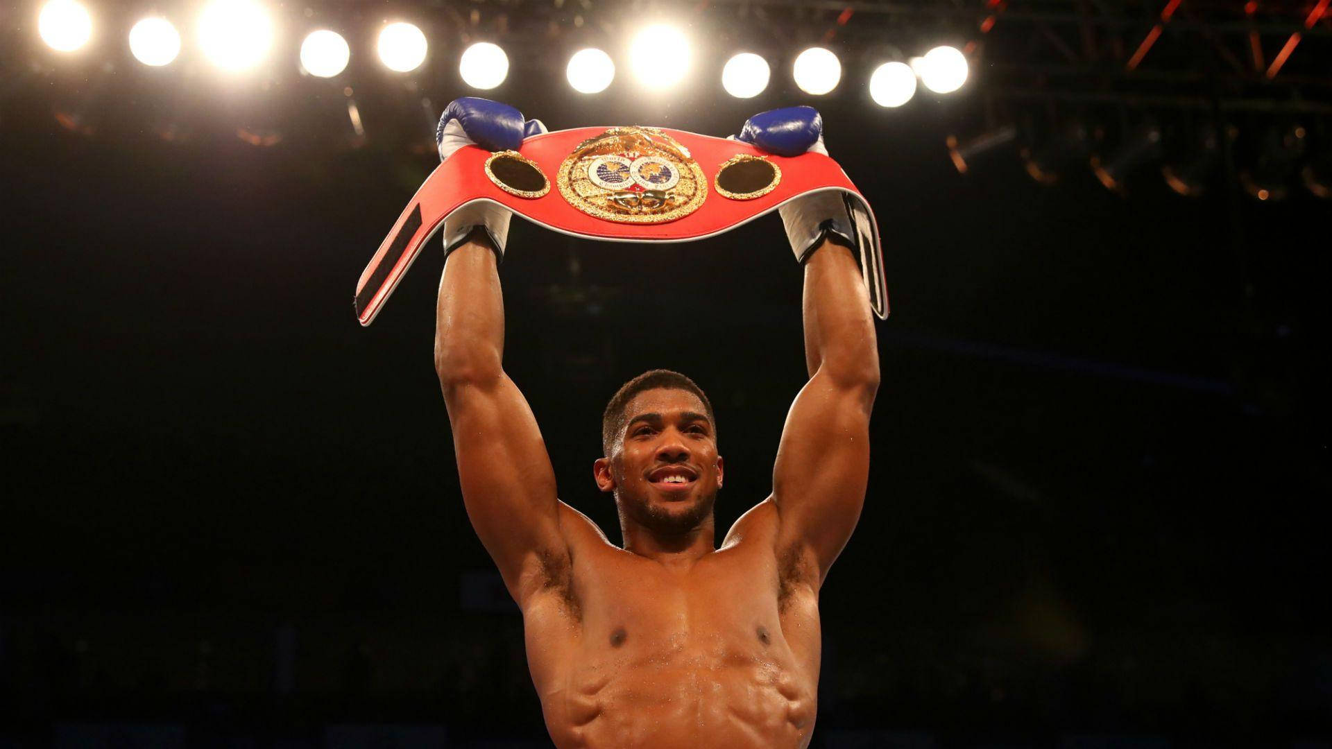 World Champion Anthony Joshua Flaunting His Red Belt Background