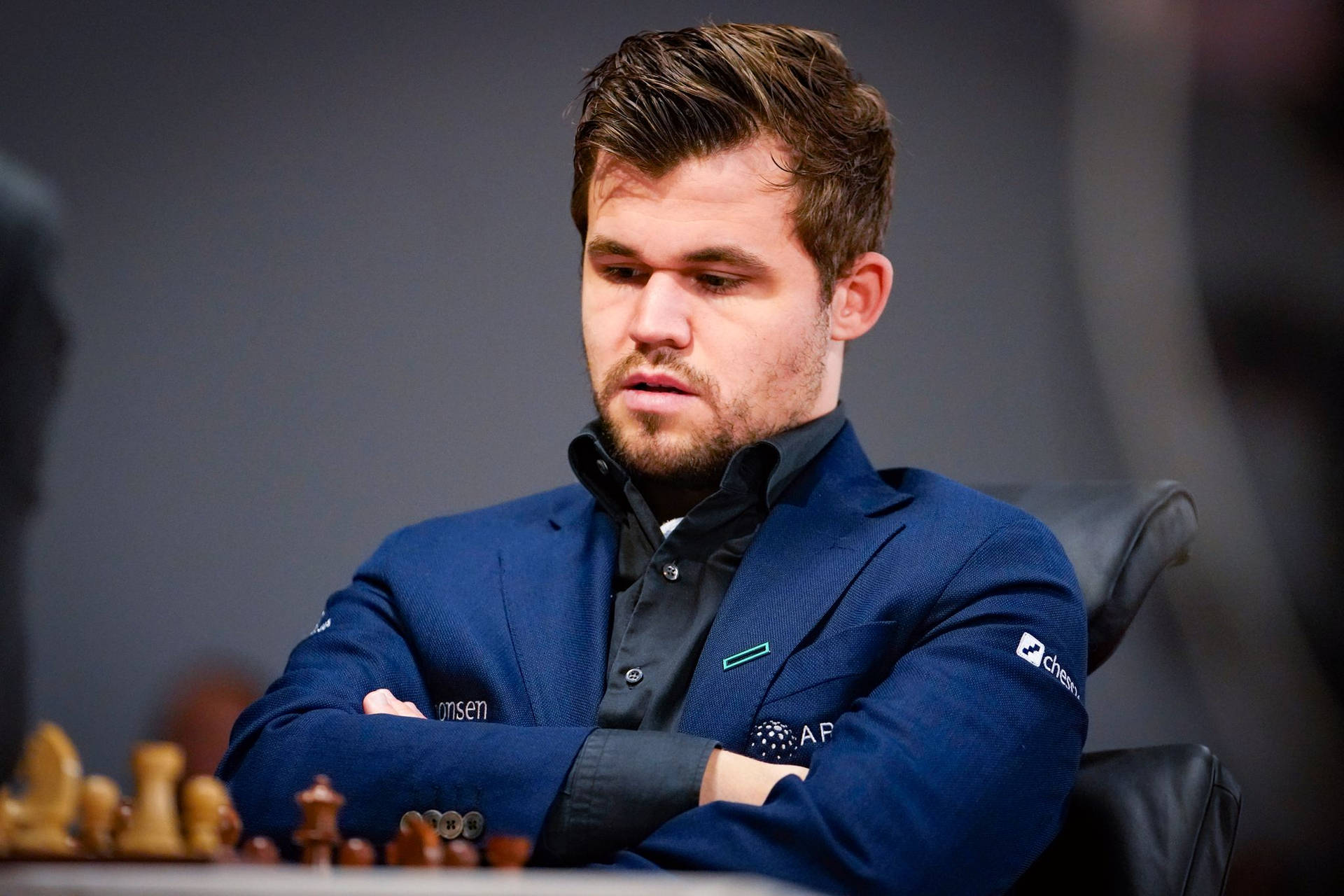 World Chess Champion Magnus Carlsen Deep In Thought Background