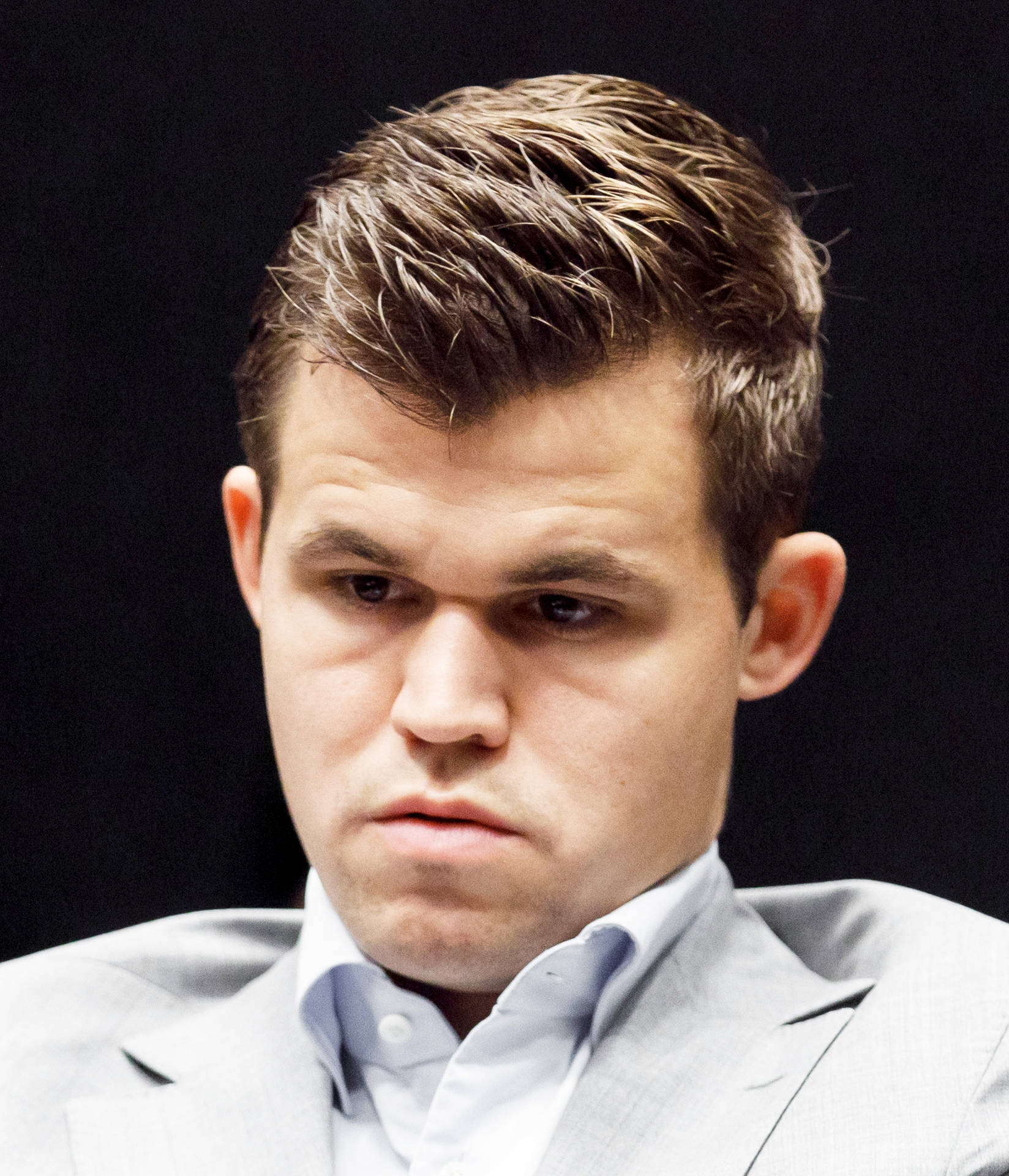 World Chess Champion Magnus Carlsen In Deep Thought Background