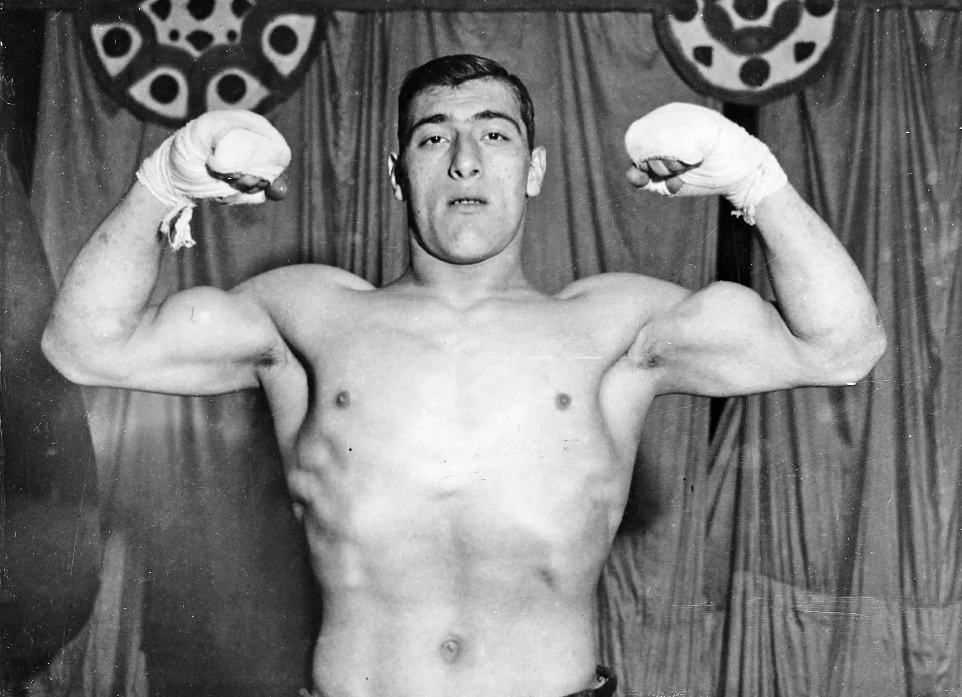 World Heavyweight Boxing Champion Primo Carnera Showcasing His Strength Background