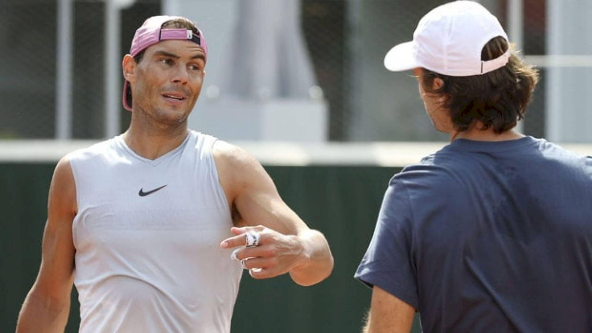 World-renowned Tennis Player Carlos Moya Poses In A White Tank Top Background