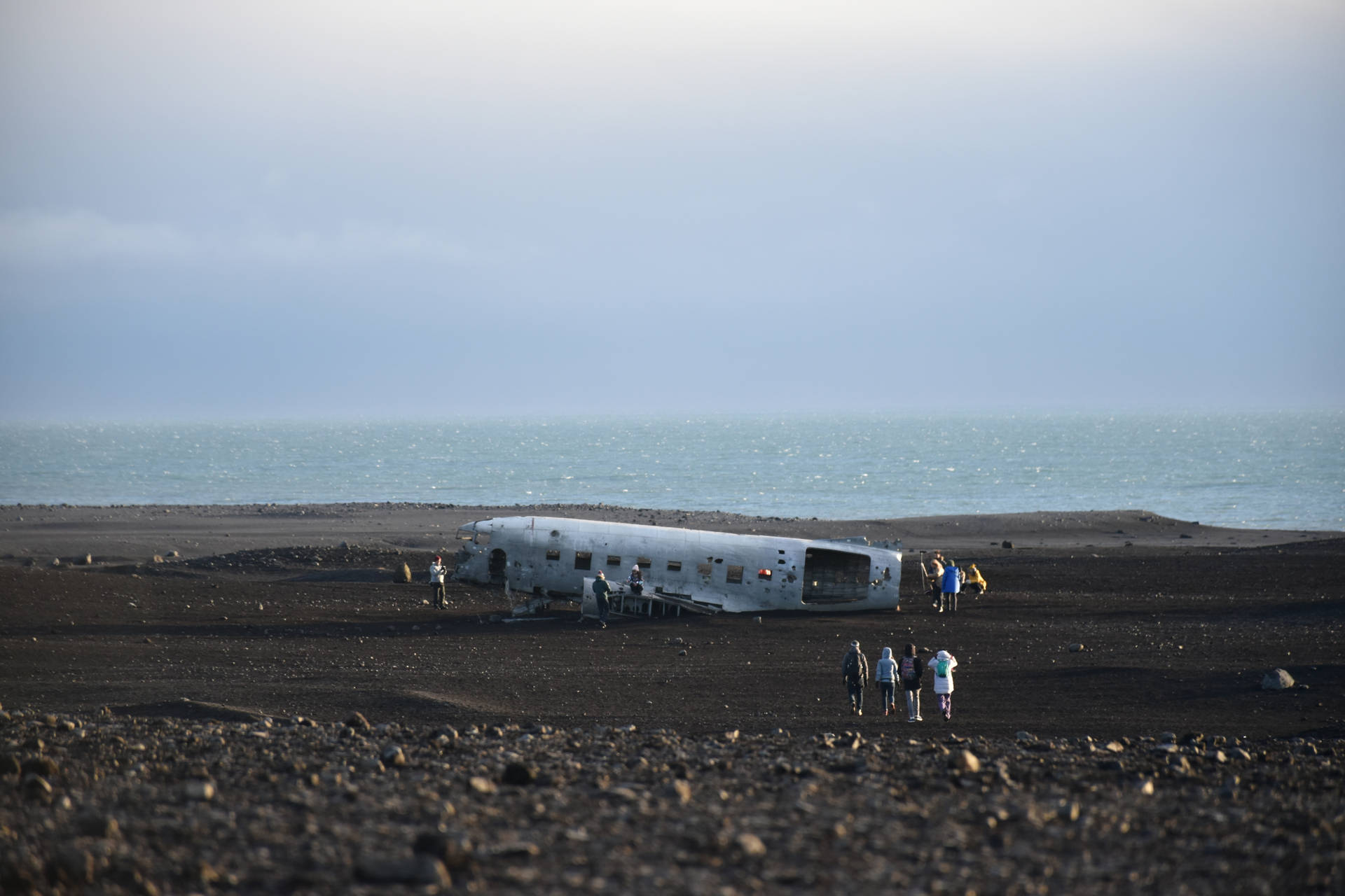 Wrecked Plane On Black Sand Background