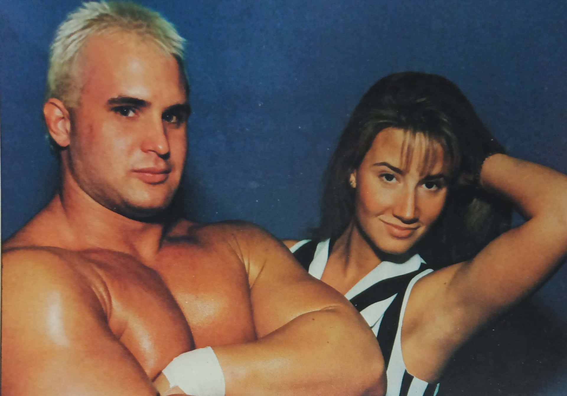 Wrestler_and_ Companion_ Blue_ Background Background