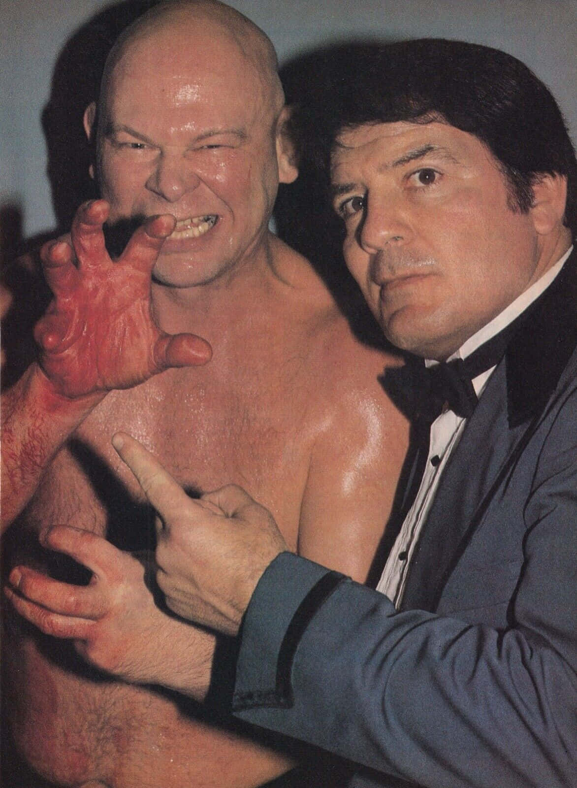 Wrestler Baron Von Raschke The Claw Posing With A Colleague Background