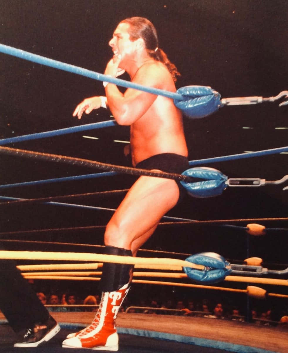 Wrestler In Action In Ring Background