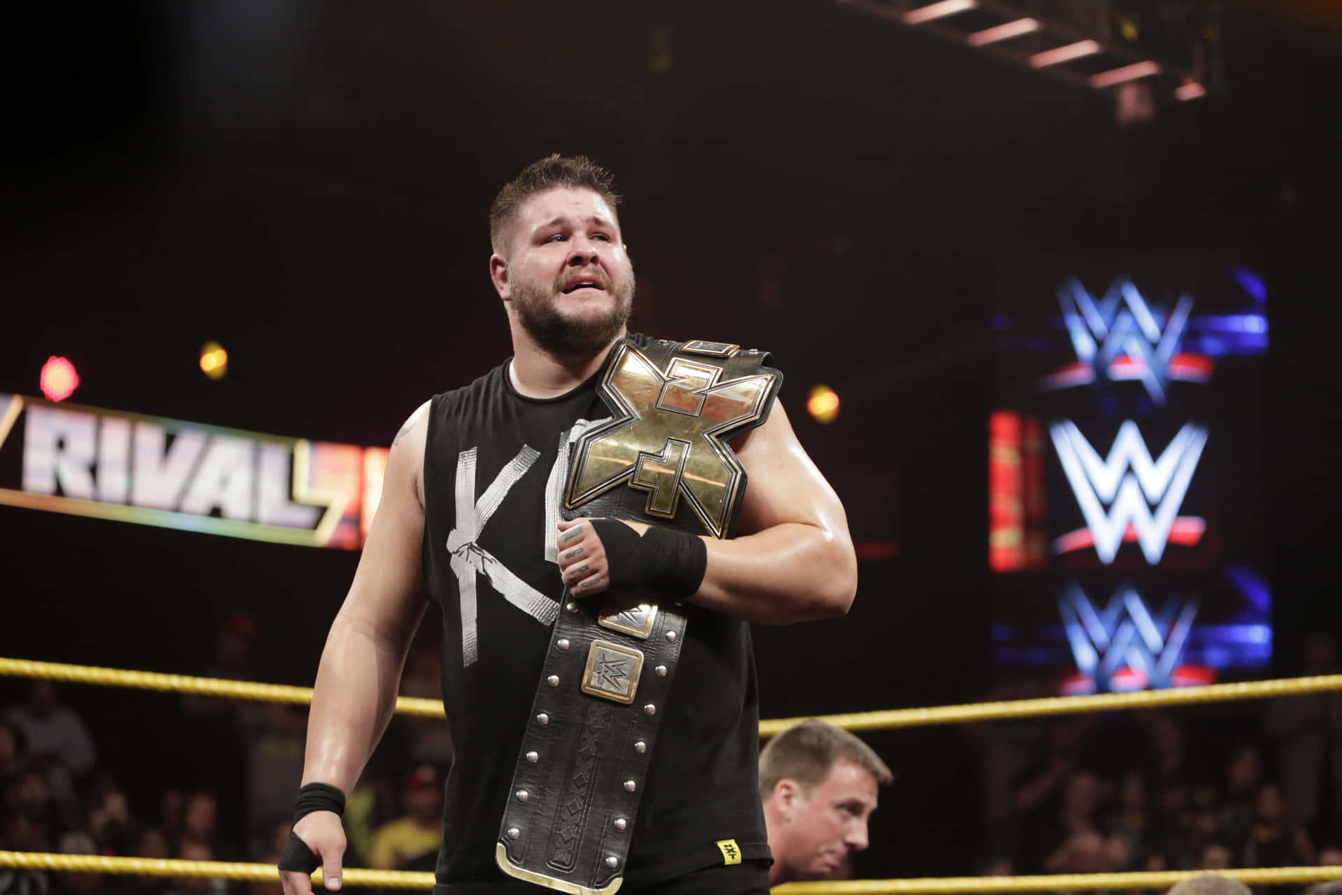 Wrestler Kevin Owens Hold The Wwe Nxt Title Background