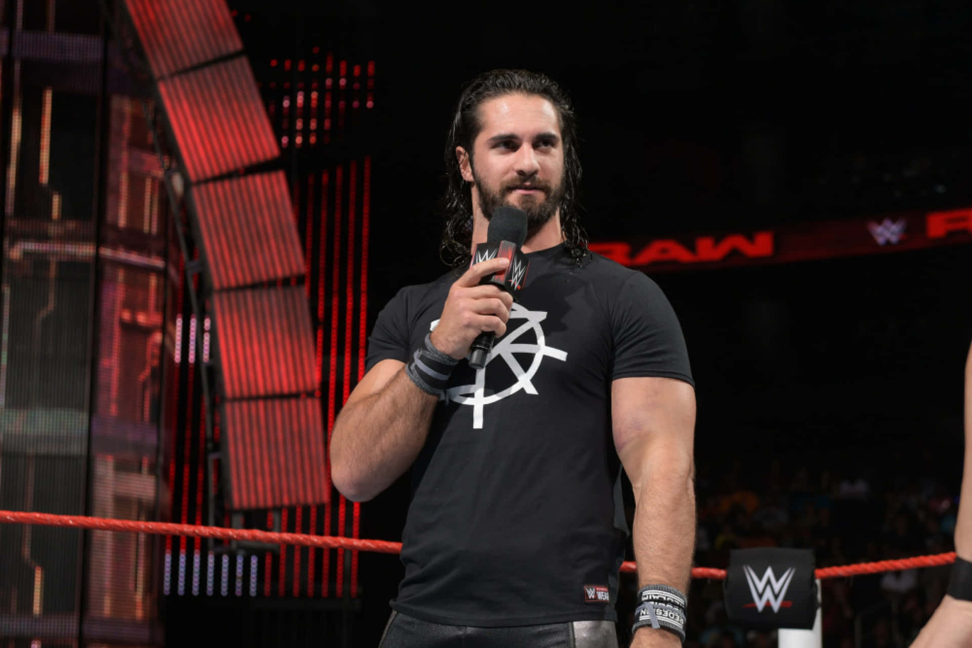 Wrestler Seth Rollins On Wwe Arena Background