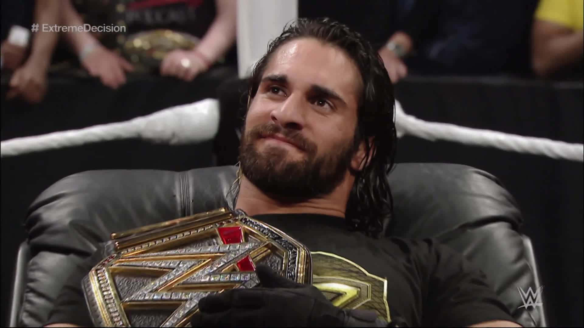 Wrestler Seth Rollins With Championship Belt Background