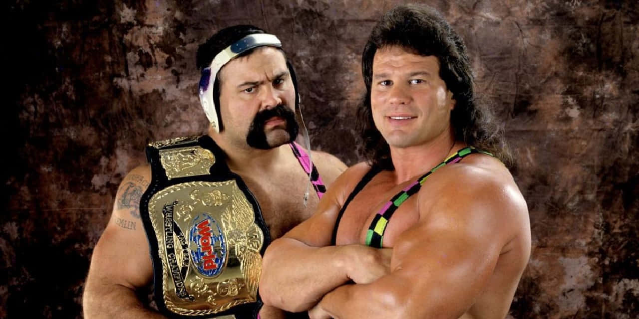 Wrestling_ Champions_ Pose_with_ Belt Background